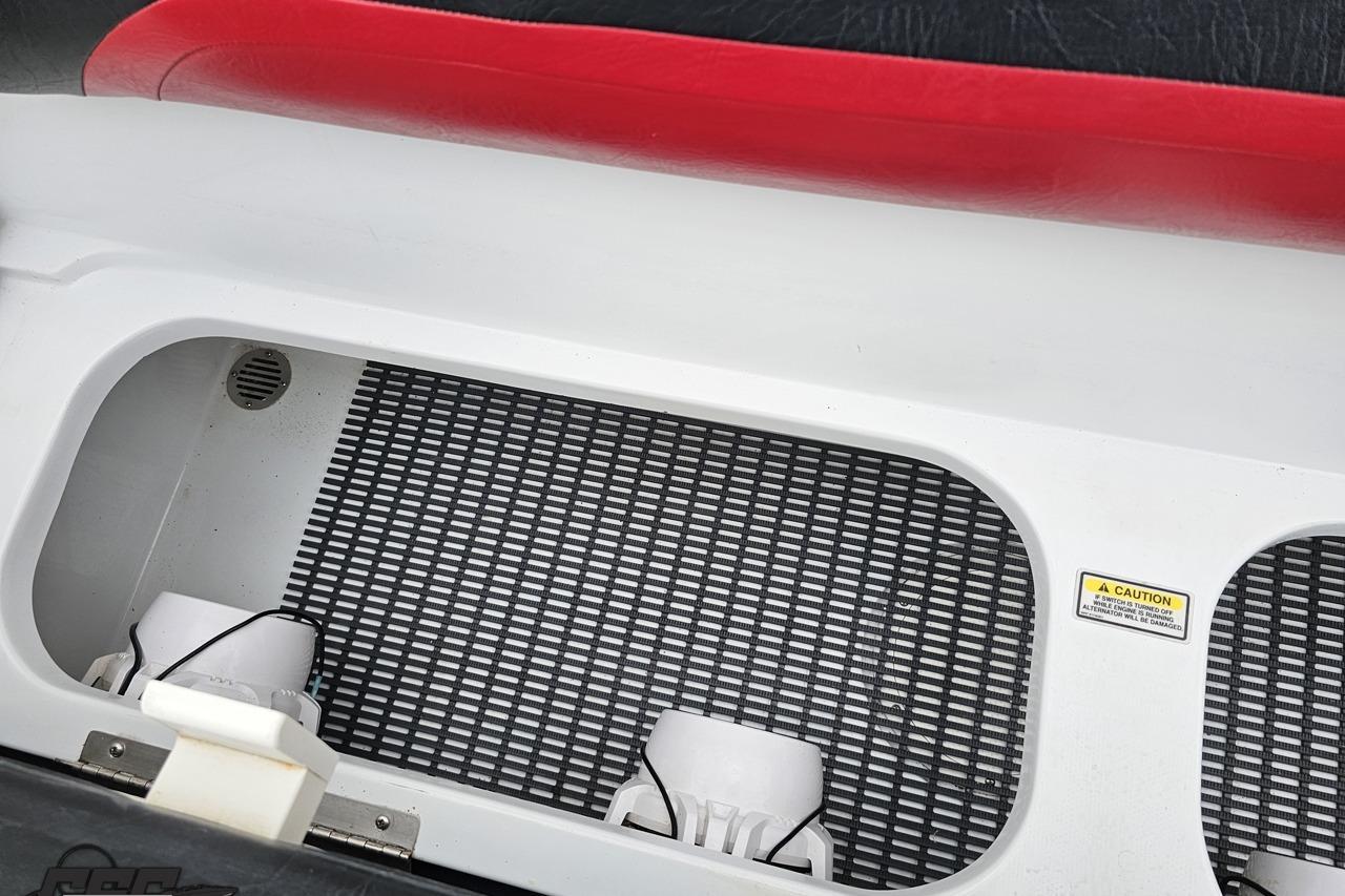 Interior view of a 2004 Baja 275 boat compartment with caution label.