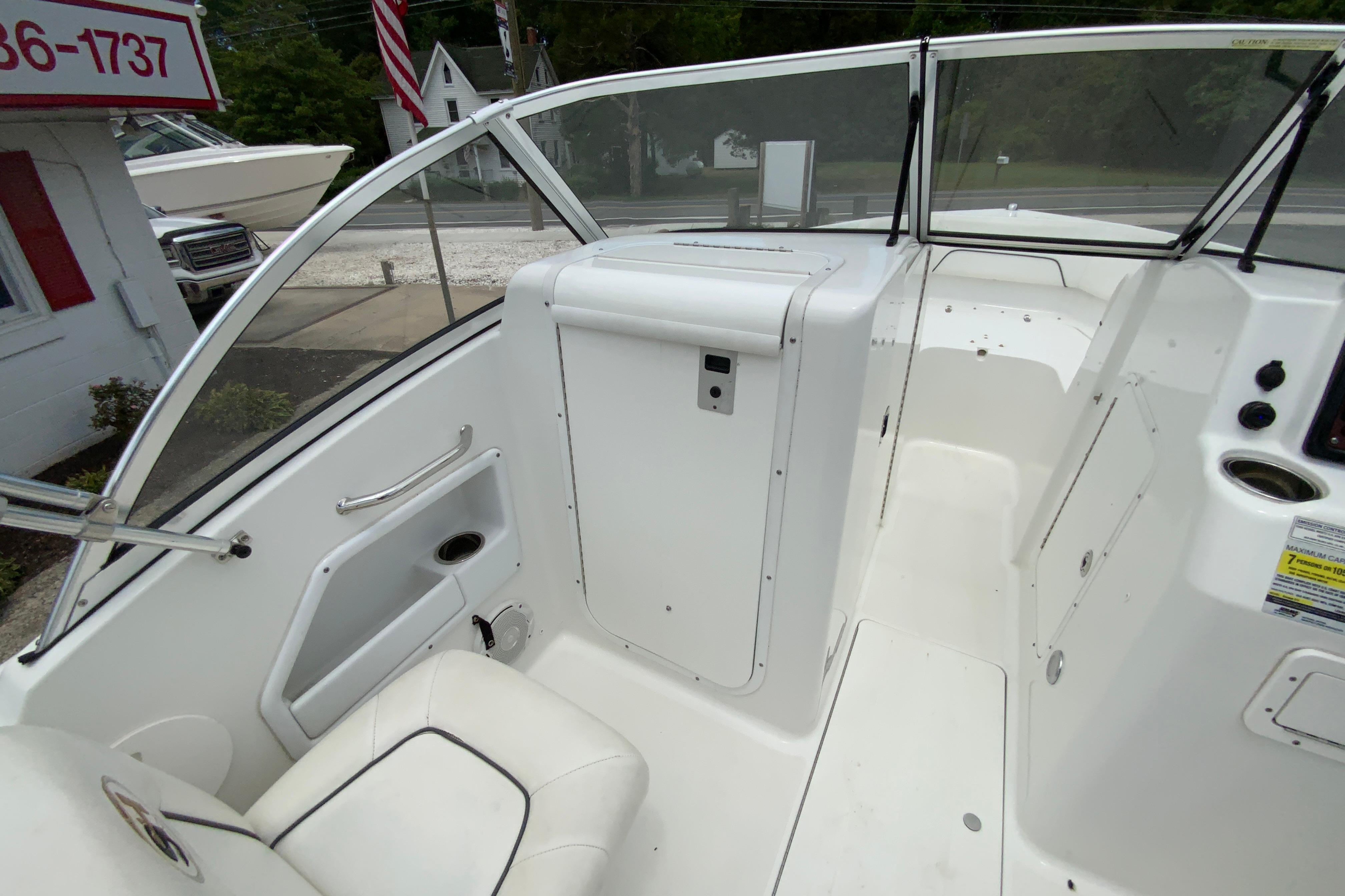 2014 Sea Hunt Escape 211 LE boat interior with white seating and dashboard.
