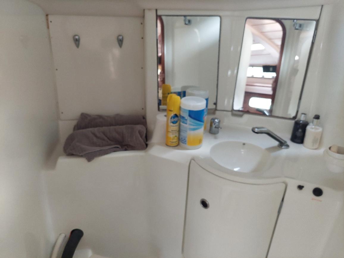 Bathroom interior of 1995 Beneteau Oceanis 351 yacht with sink and toiletries.