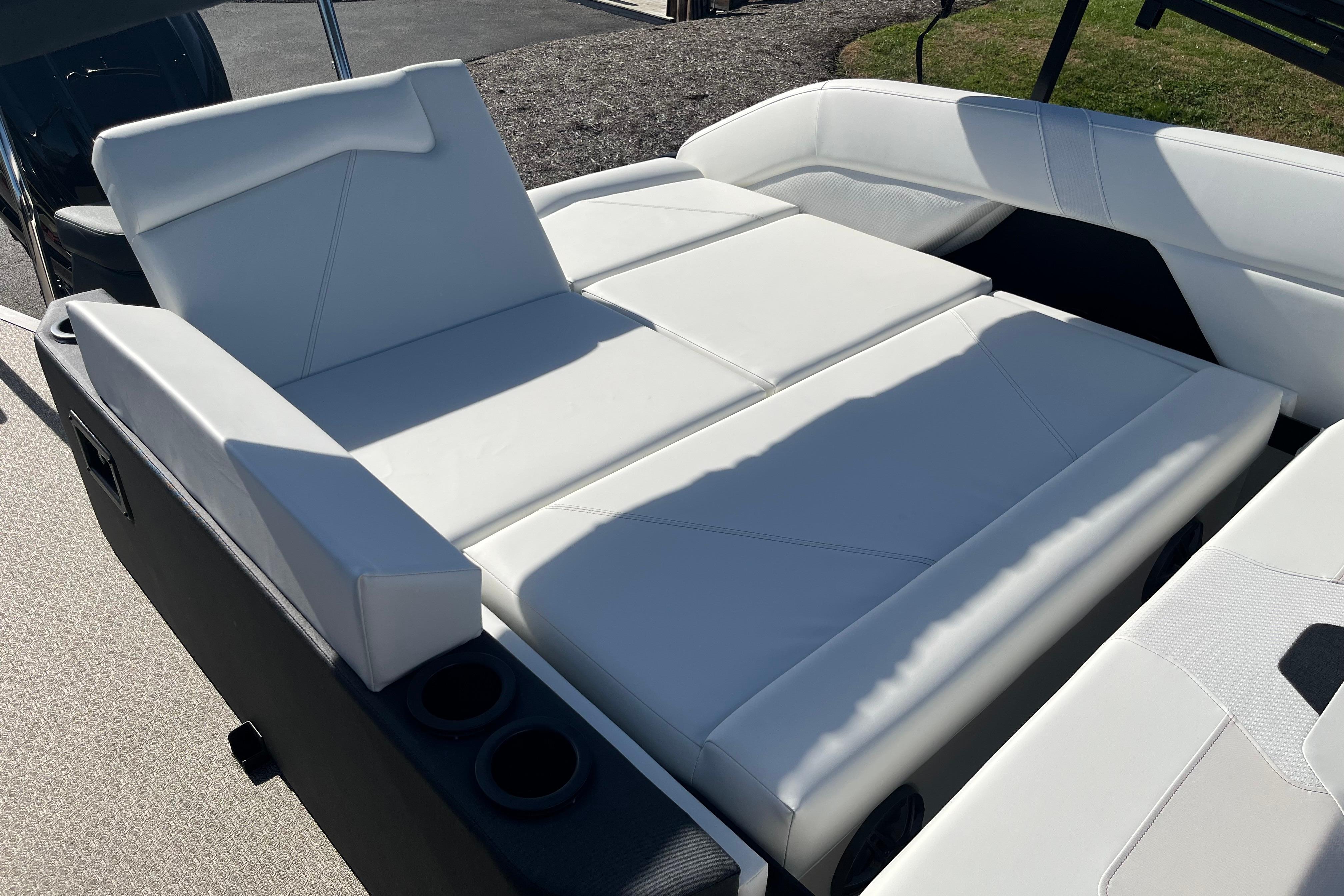 Luxurious white seating on 2026 Evotti 523CS boat, featuring cup holders and modern design.
