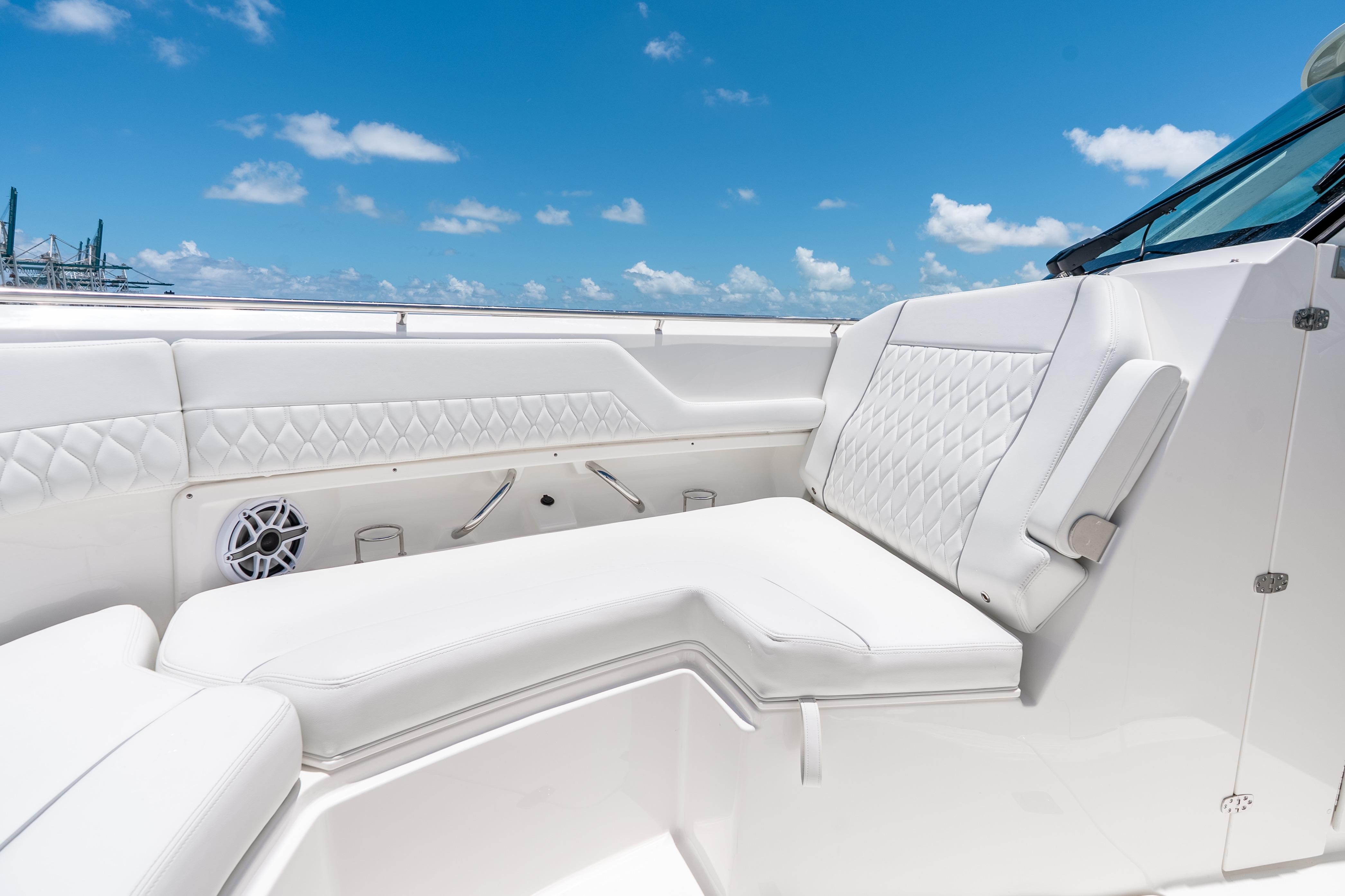 2026 Pursuit DC 326 Dual Console boat interior with white seating under blue sky.