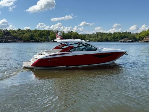 2022 Cobalt A36BR boat on a calm lake under a clear blue sky.