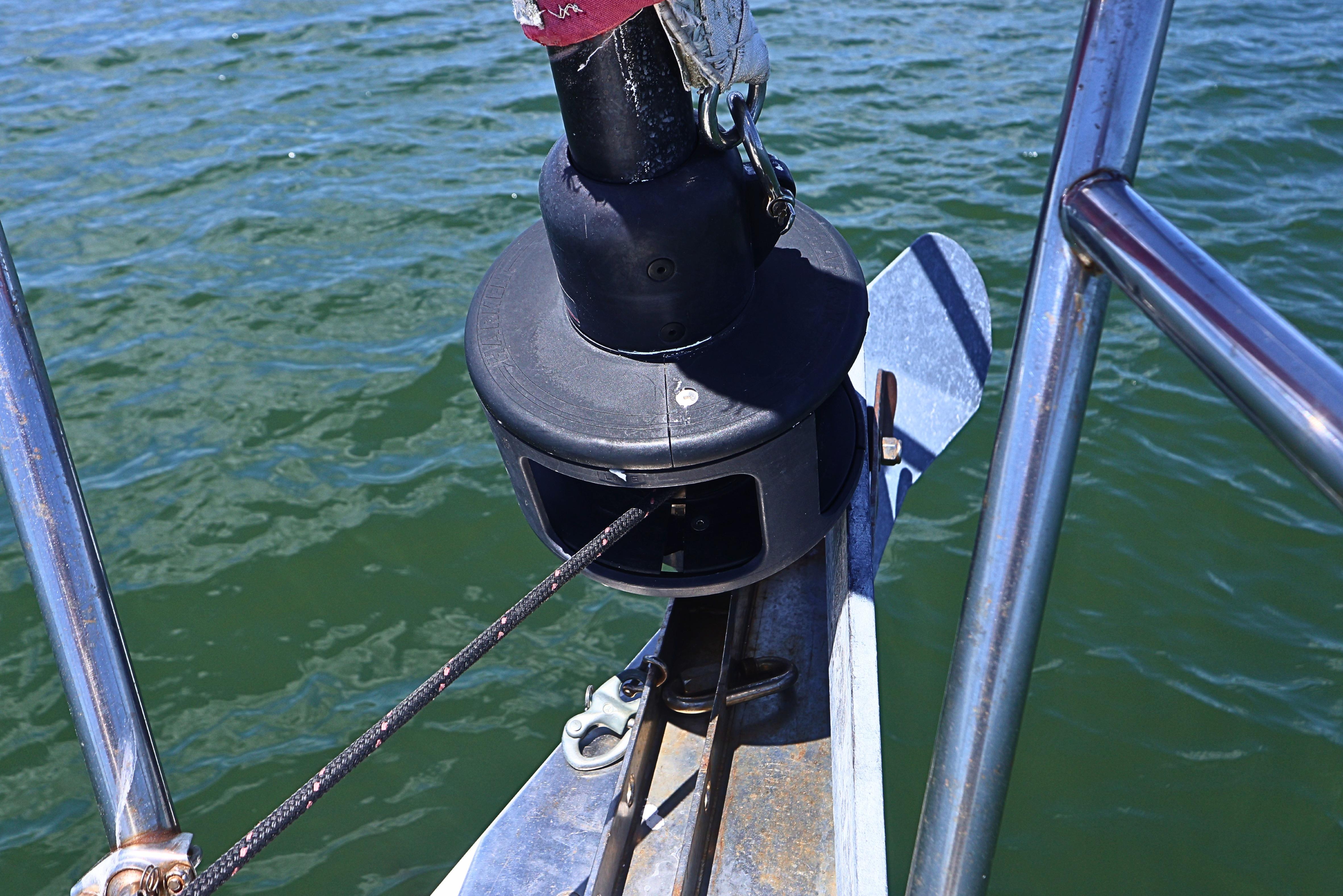 Close-up of a 1989 J Boat J 40 sailboat's bow with furler and railing.