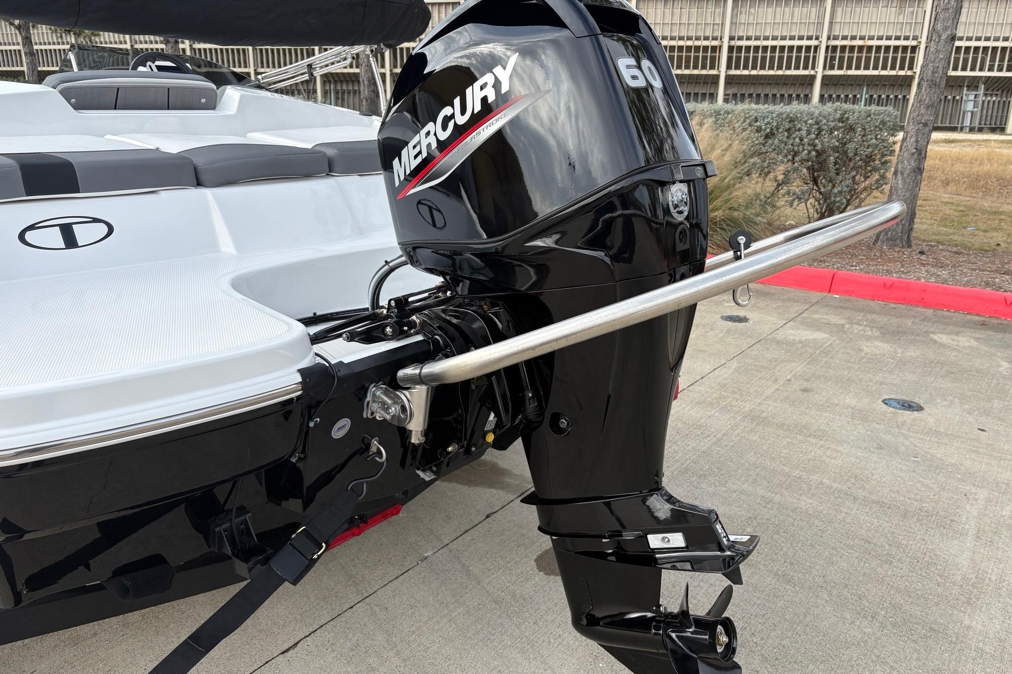 2025 Tahoe T16 boat with Mercury 60 outboard motor, parked on concrete surface.