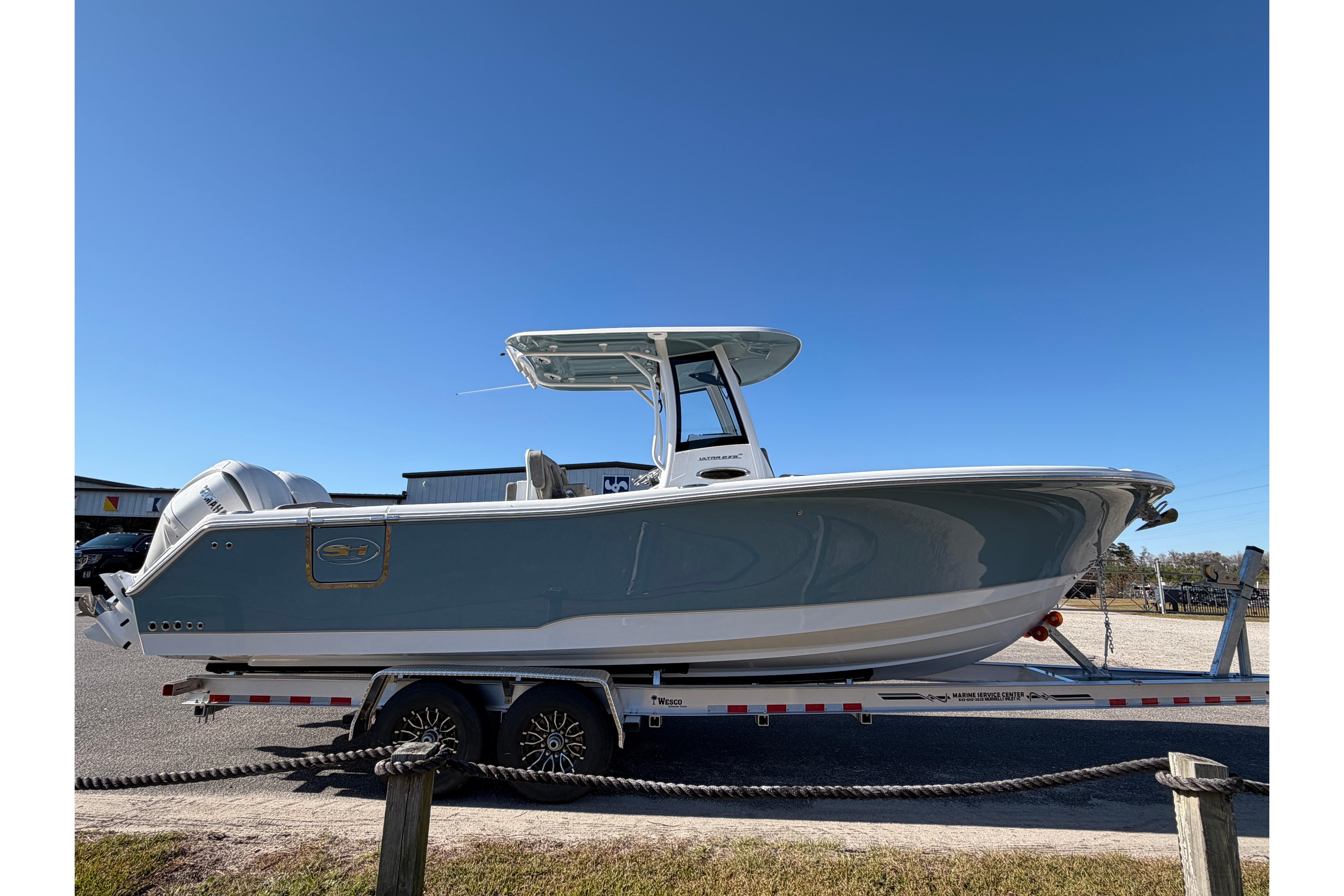 2026 Sea Hunt Ultra 275 Coffin Box boat on trailer, clear sky background.