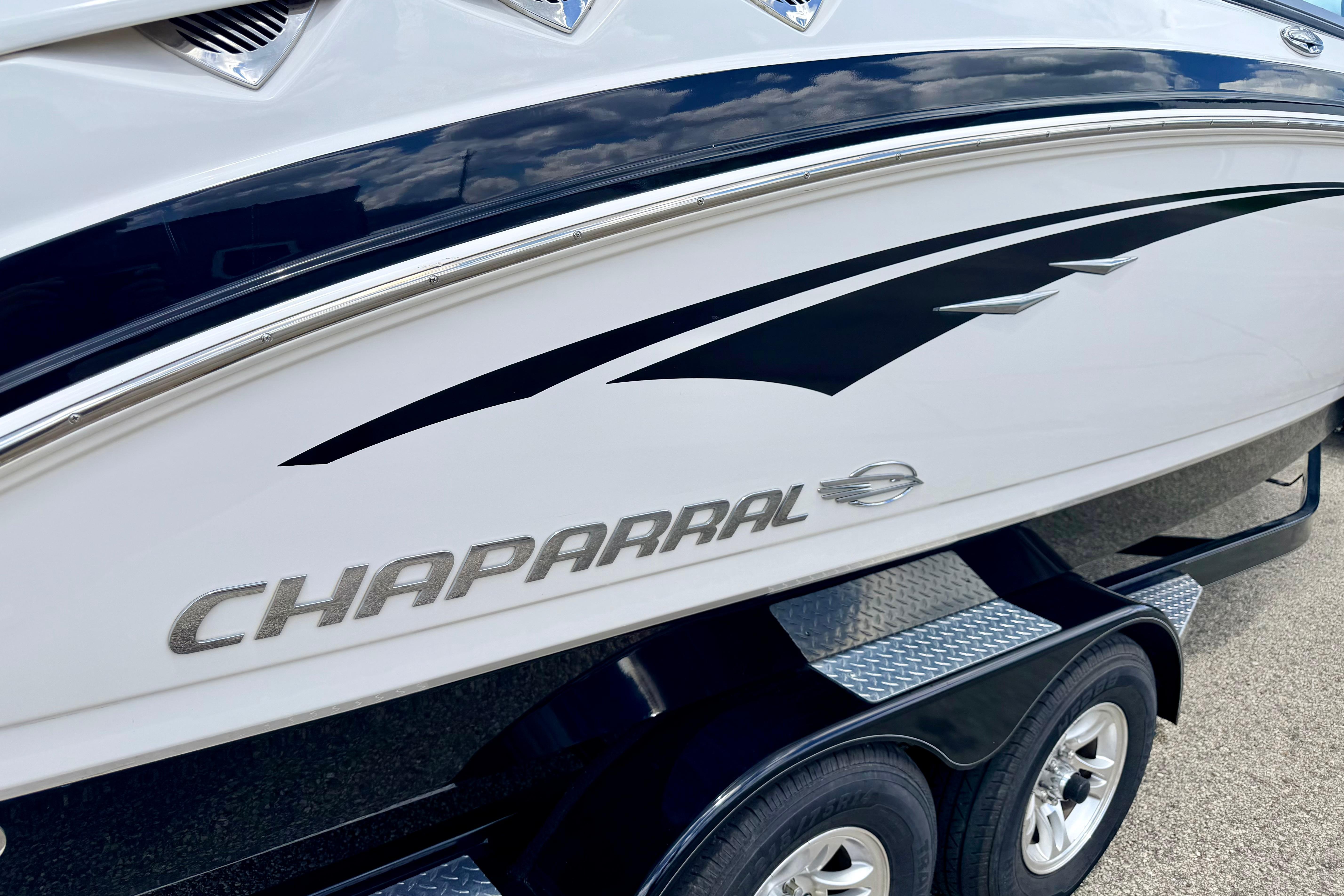 2015 Chaparral Sunesta 264 boat side view with logo and sleek design.