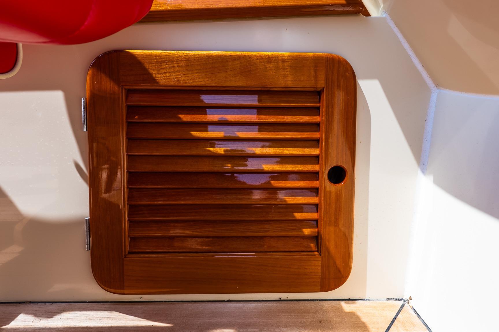 Wooden hatch on 2005 Hinckley Talaria 29R boat, showcasing polished craftsmanship.