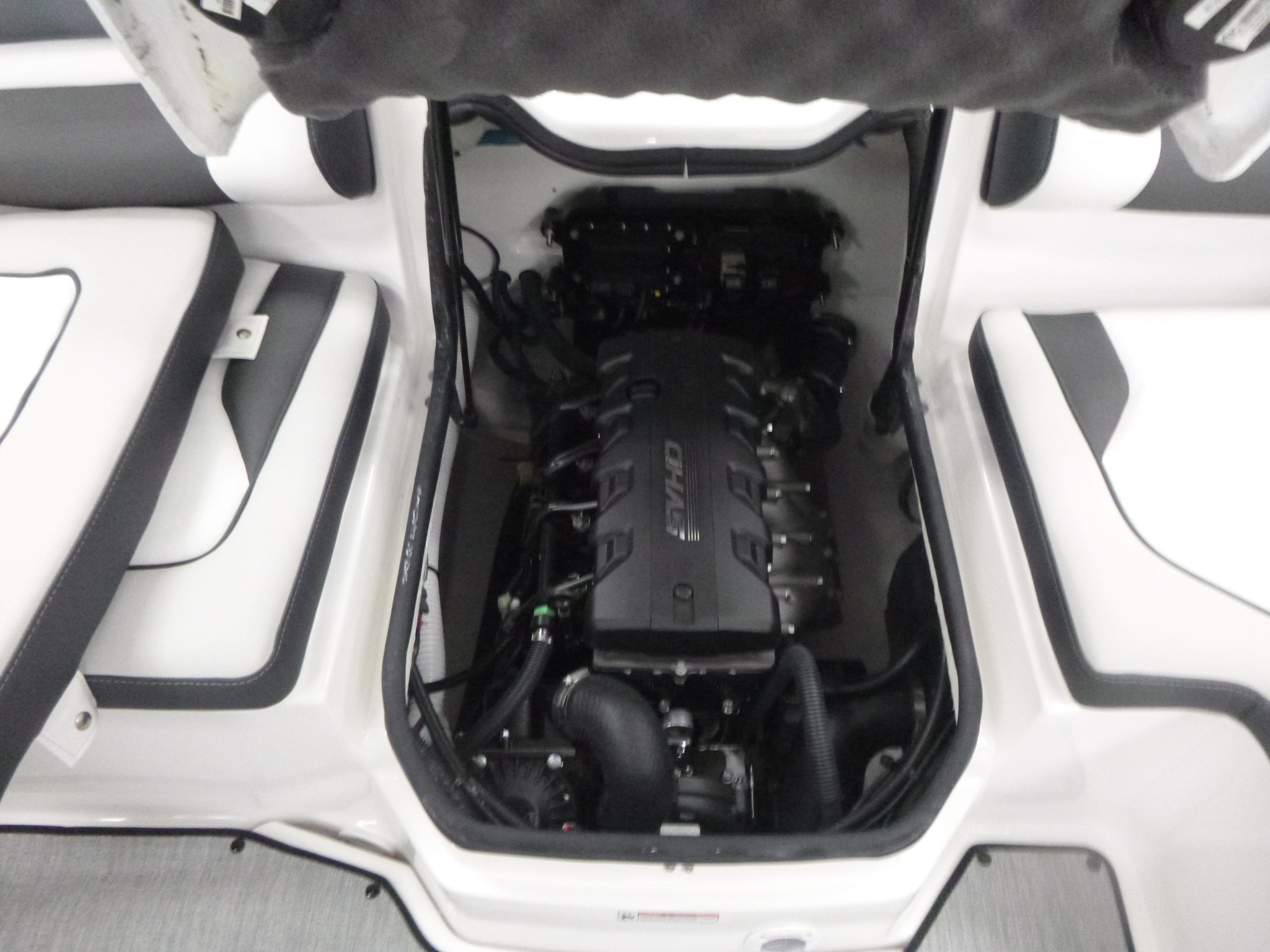 2025 Yamaha Boats AR195 engine compartment with visible components and seating area.