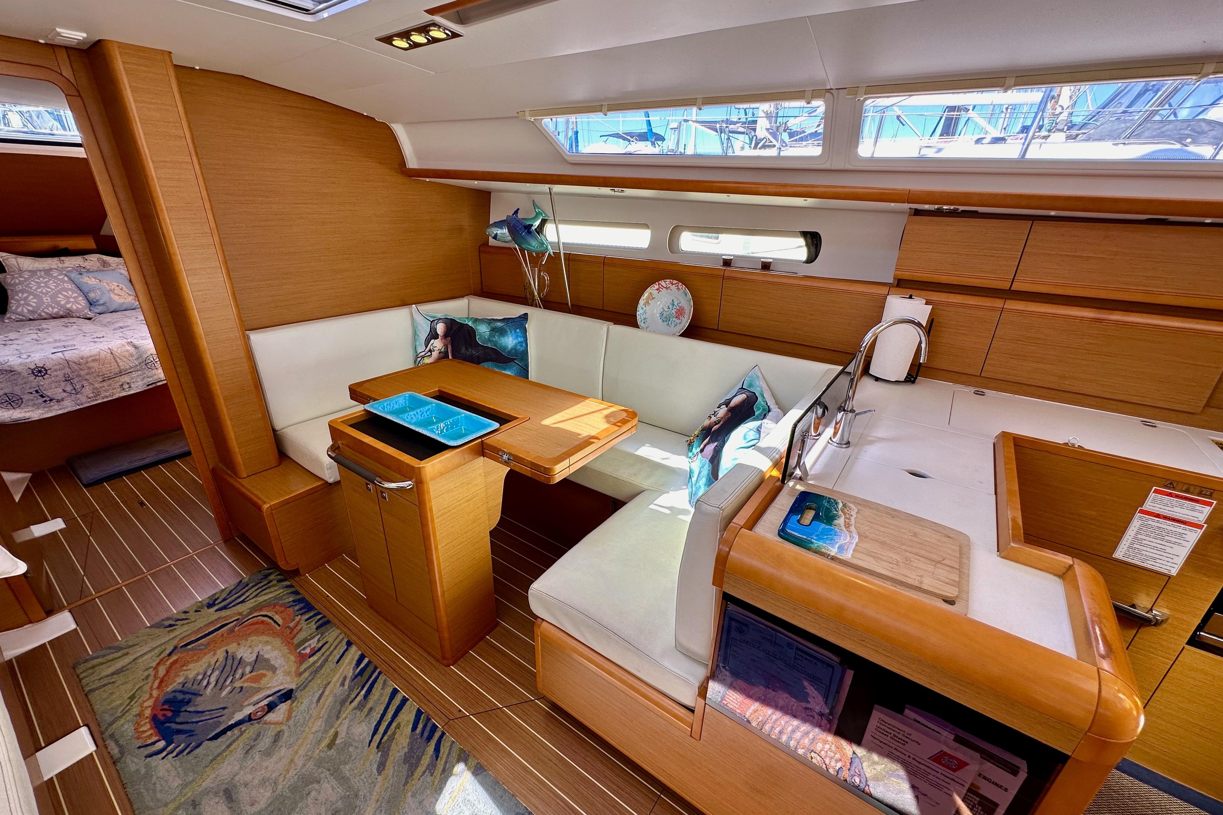 Interior of 2015 Jeanneau Sun Odyssey 409 sailboat with cozy seating and modern design.