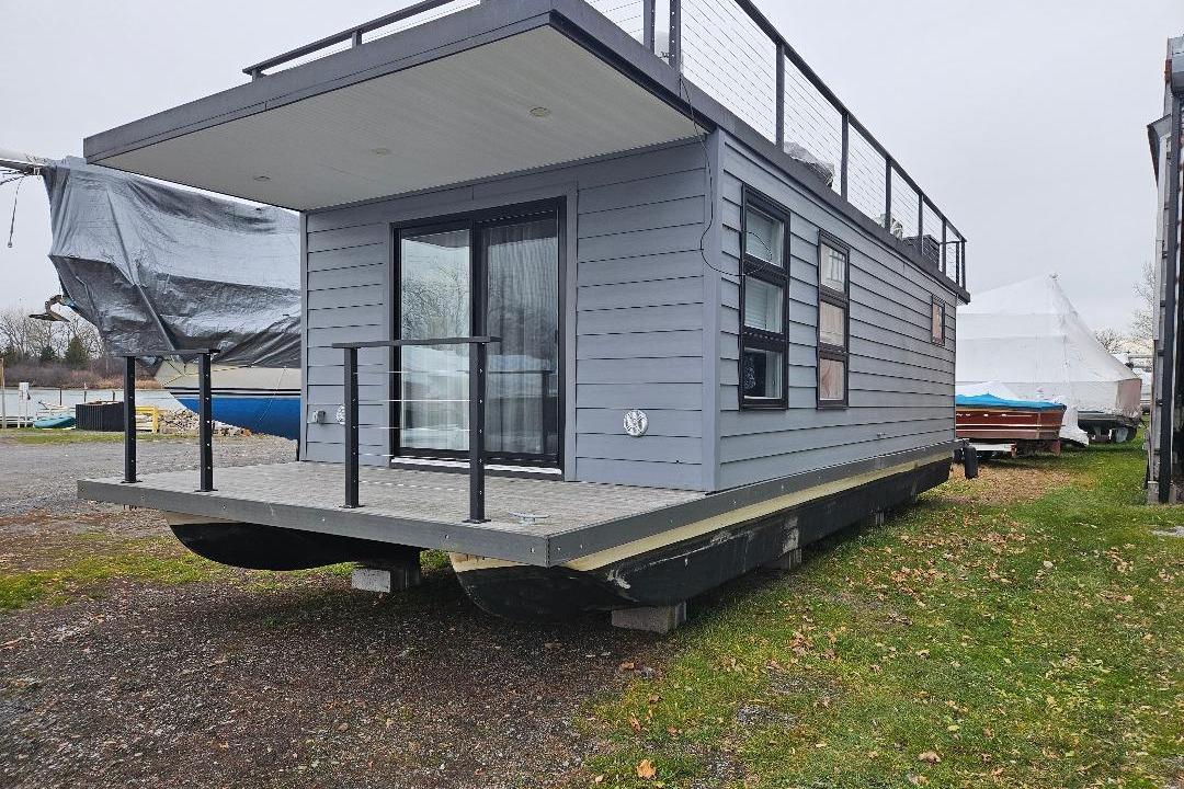 Modern 2021 East Coast Houseboats Freedom 40 with sleek design and spacious deck.