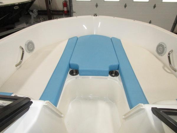 2023 Bayliner 210EL boat interior with blue seating and cup holders.