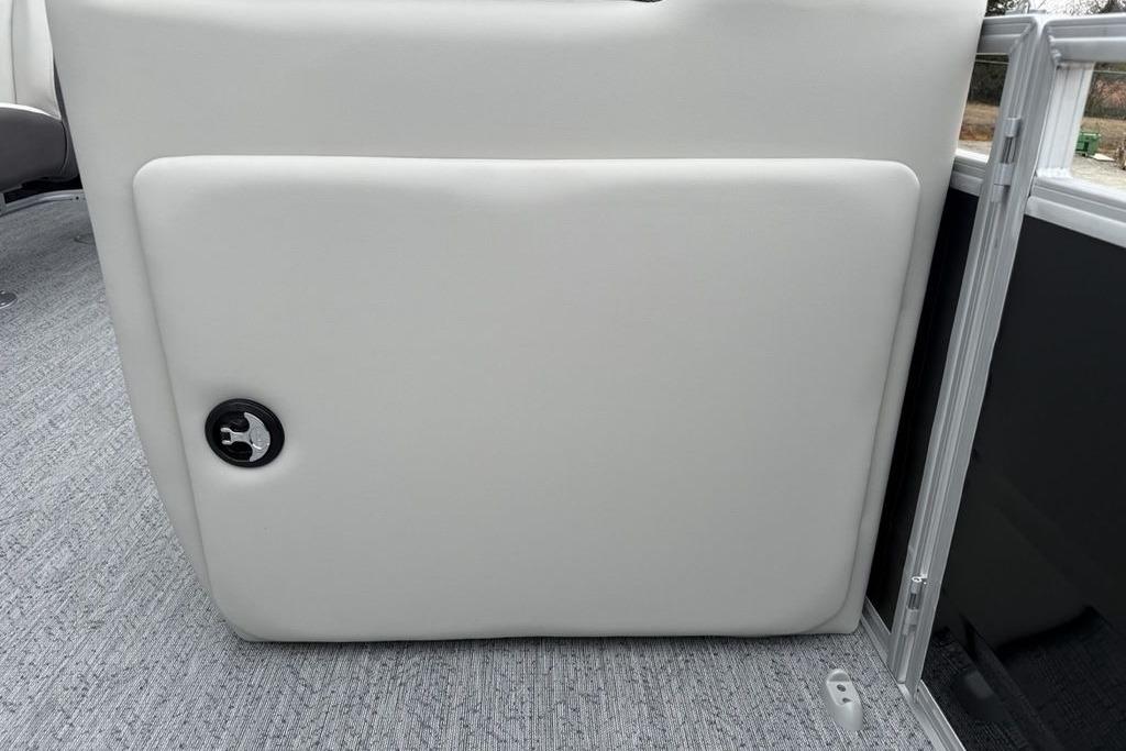 2026 Sun Tracker Fishin' Barge 20 DLX interior detail with white panel and latch.