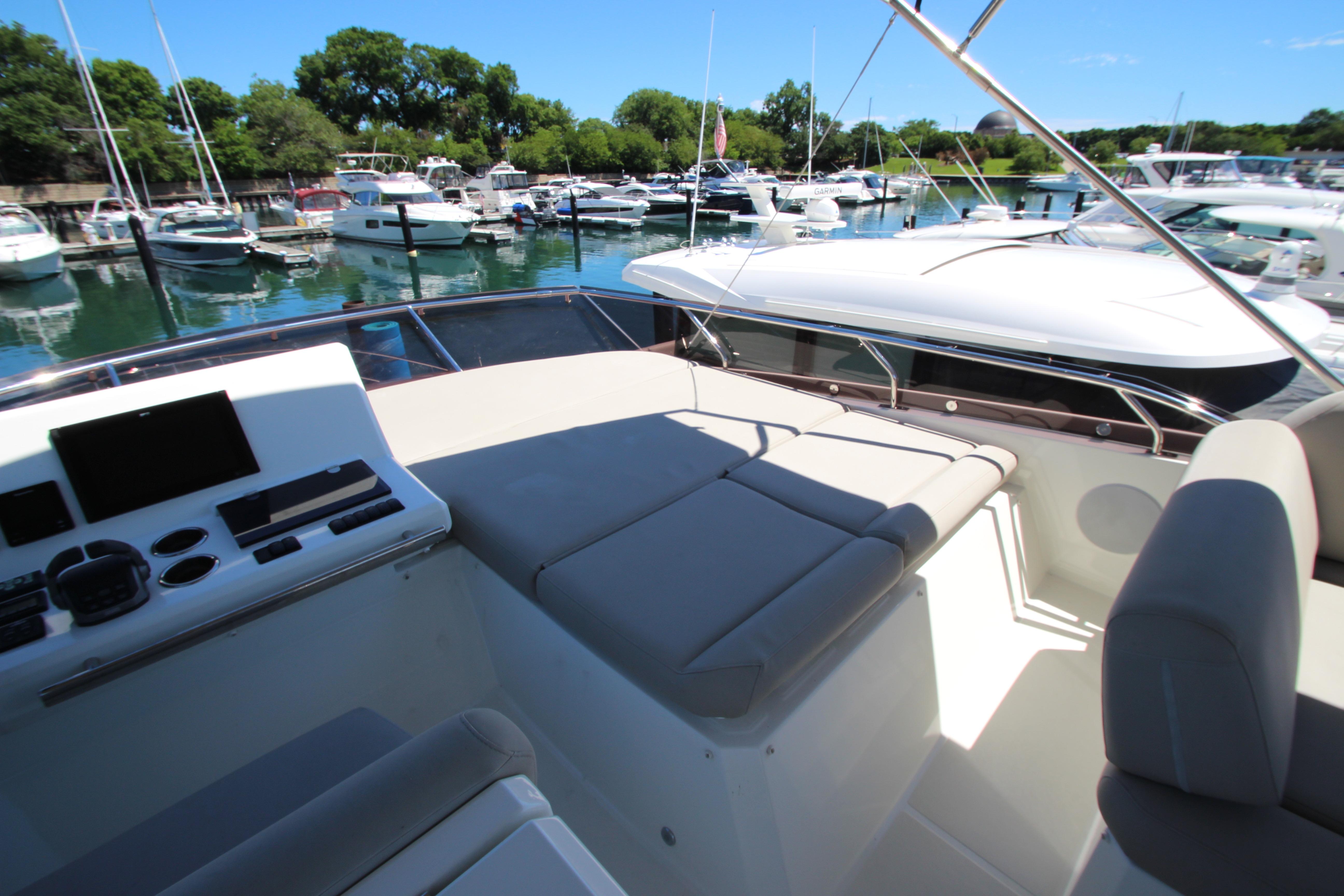 Prestige 520 yacht interior, 2022 model, featuring a spacious deck and modern controls in a marina.