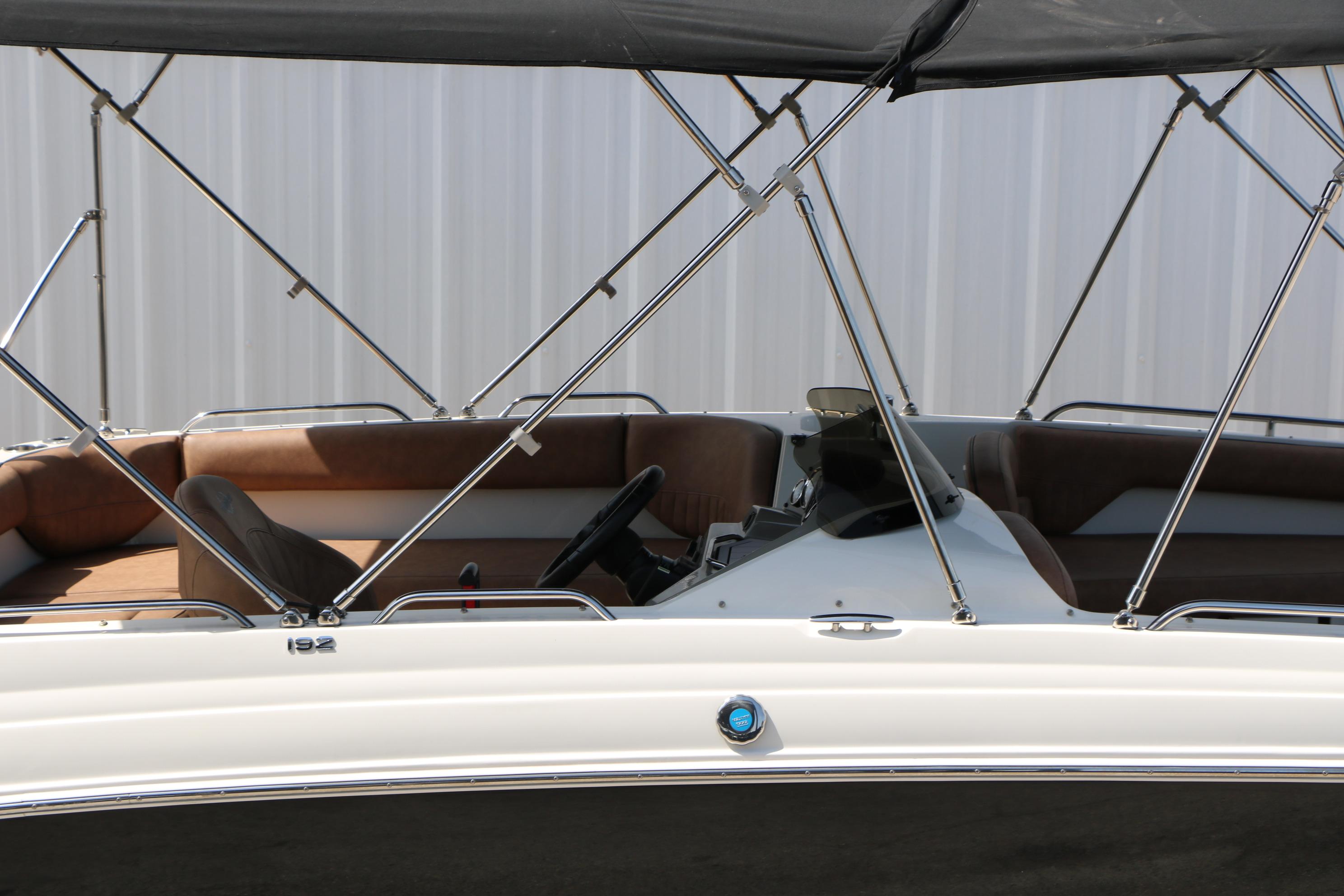 2022 Stingray 192 SC boat interior with brown seating and canopy.