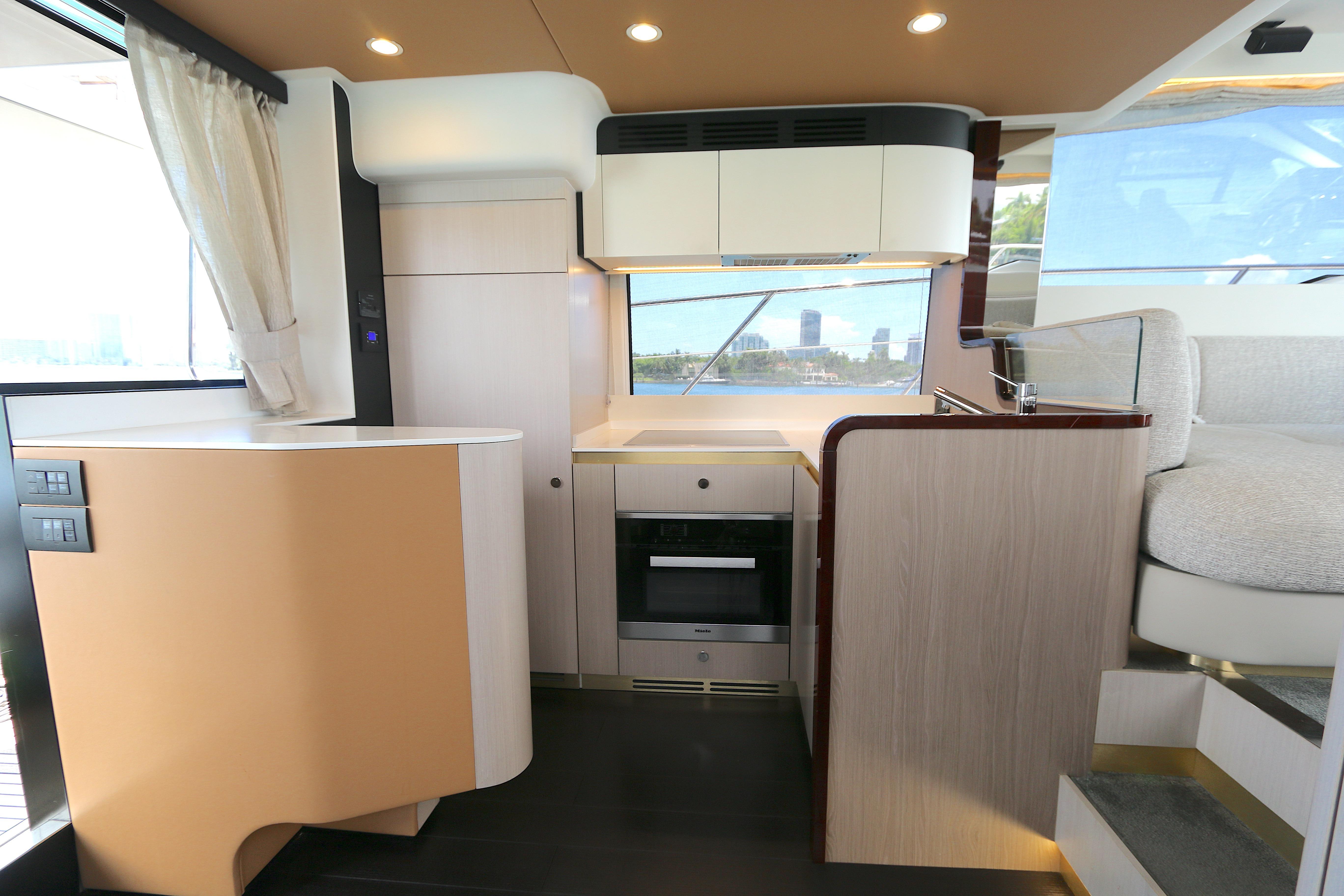 Modern kitchen interior of 2020 Azimut 55 yacht with sleek design and appliances.