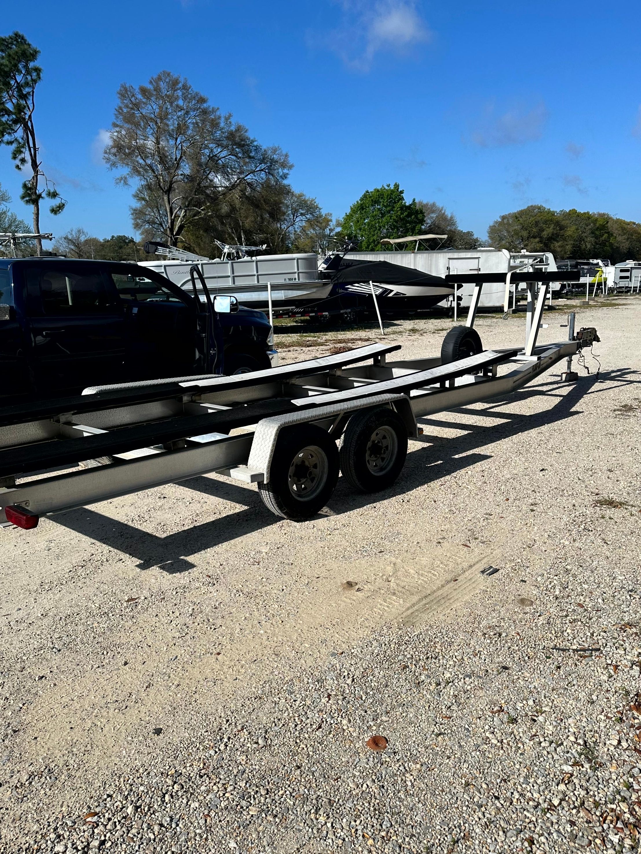 Boat trailer on gravel lot, Grady-White X26 Tigercat 2000 model.
