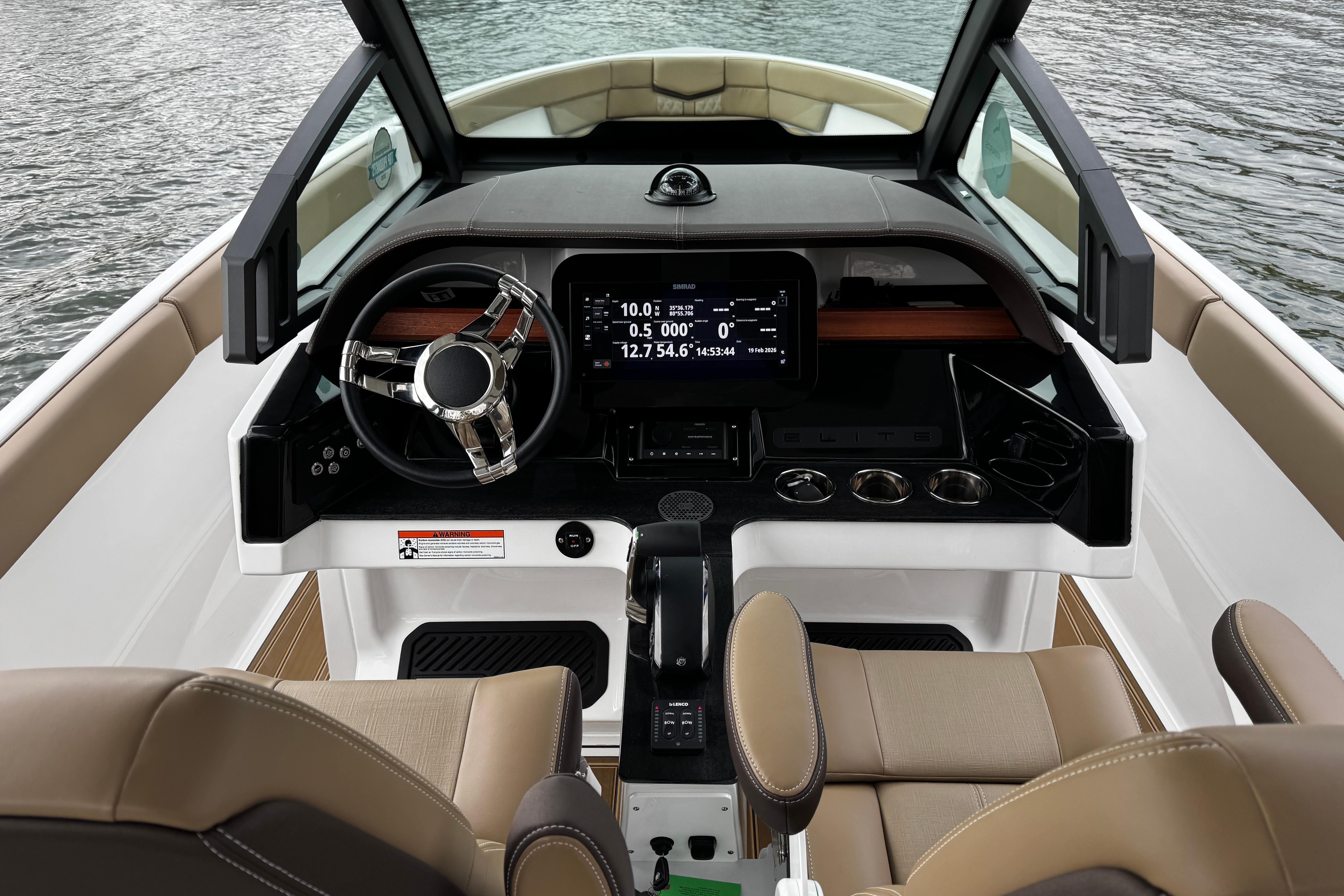 Cockpit of 2026 Monterey Elite 25 OB boat with modern steering and dashboard.