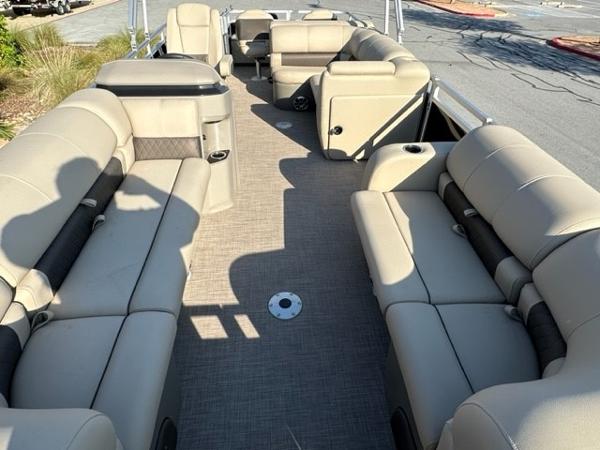 2024 Sun Tracker SportFish 22 DLX pontoon boat with spacious seating and modern design.