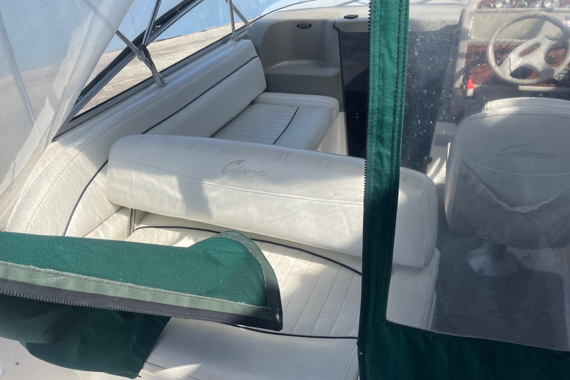 1997 Bayliner 2655 Ciera boat interior with white seating and green canopy.