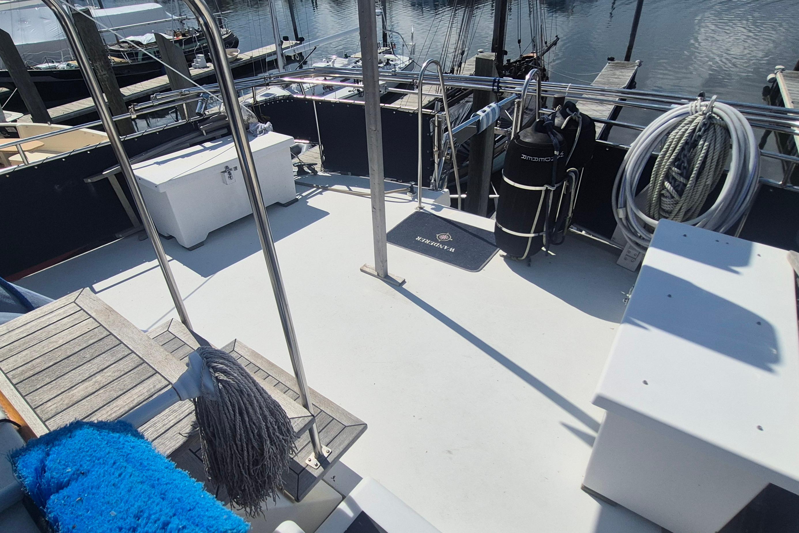 Deck of 1983 Grand Banks 42 Motoryacht with nautical equipment and dock view.