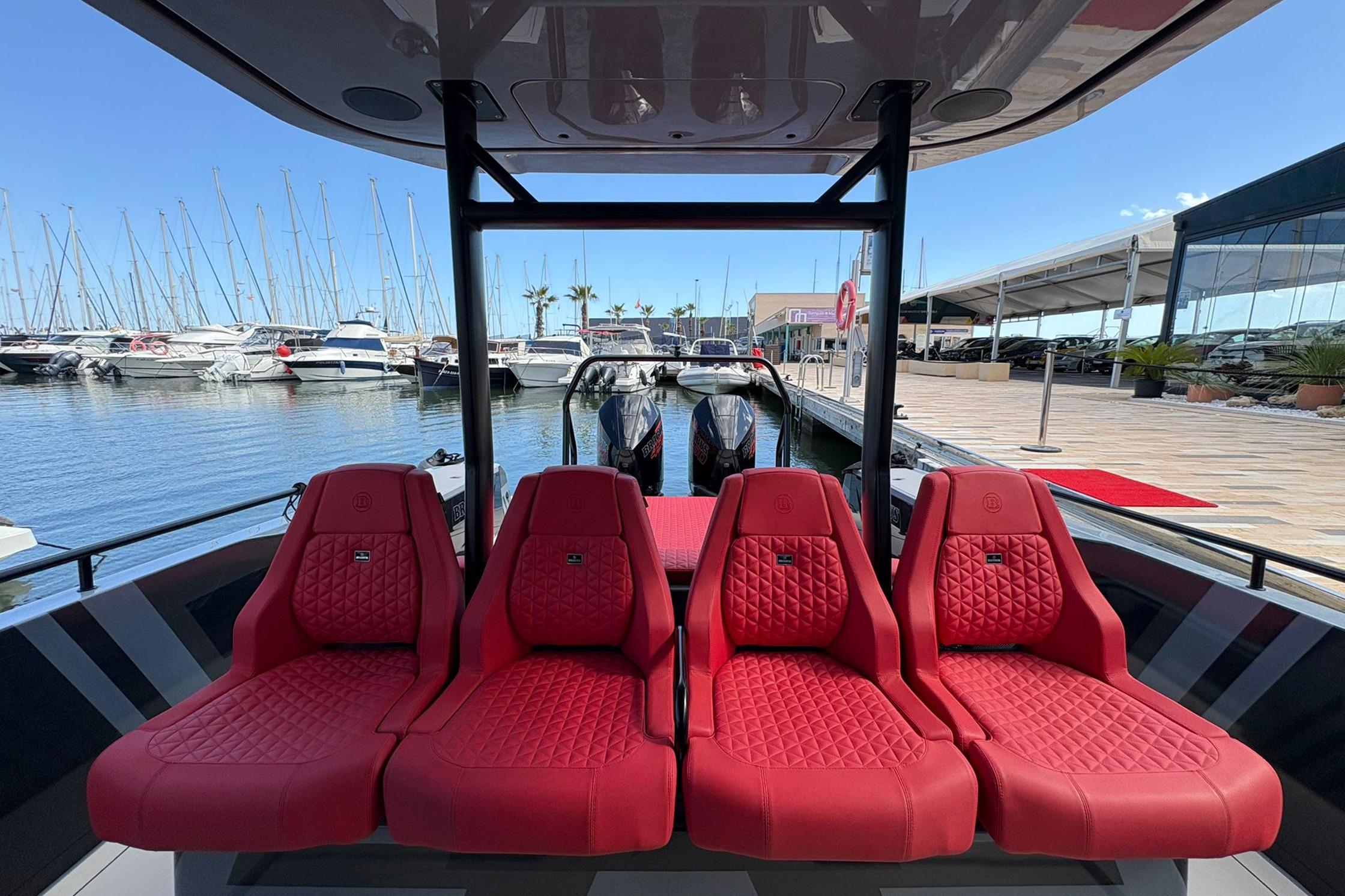 2023 BRABUS Shadow 900 Sun Top with luxurious red seating at a marina.
