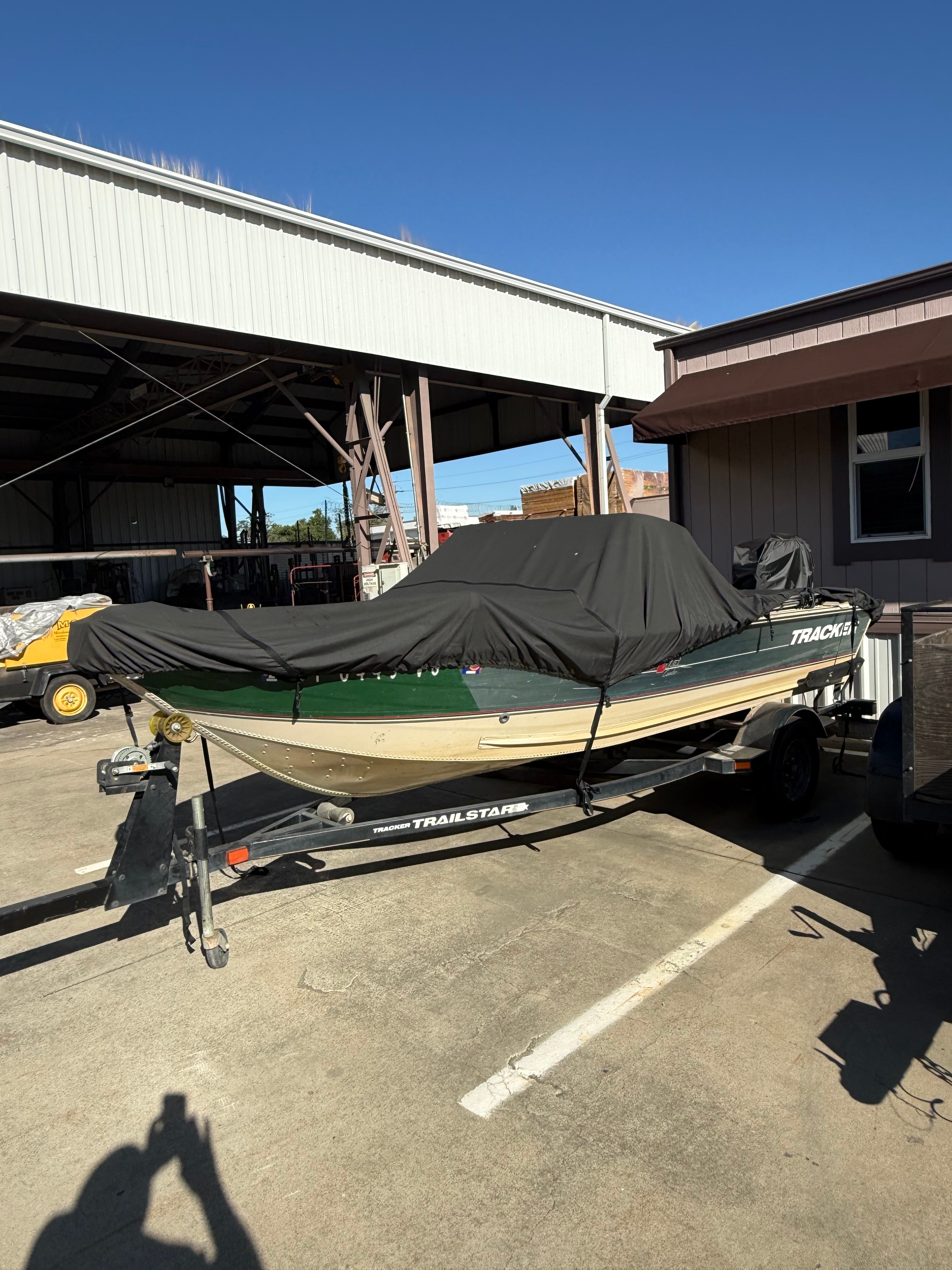 2002 Bass Tracker Pro Deep V-16 Combo on trailer, covered.