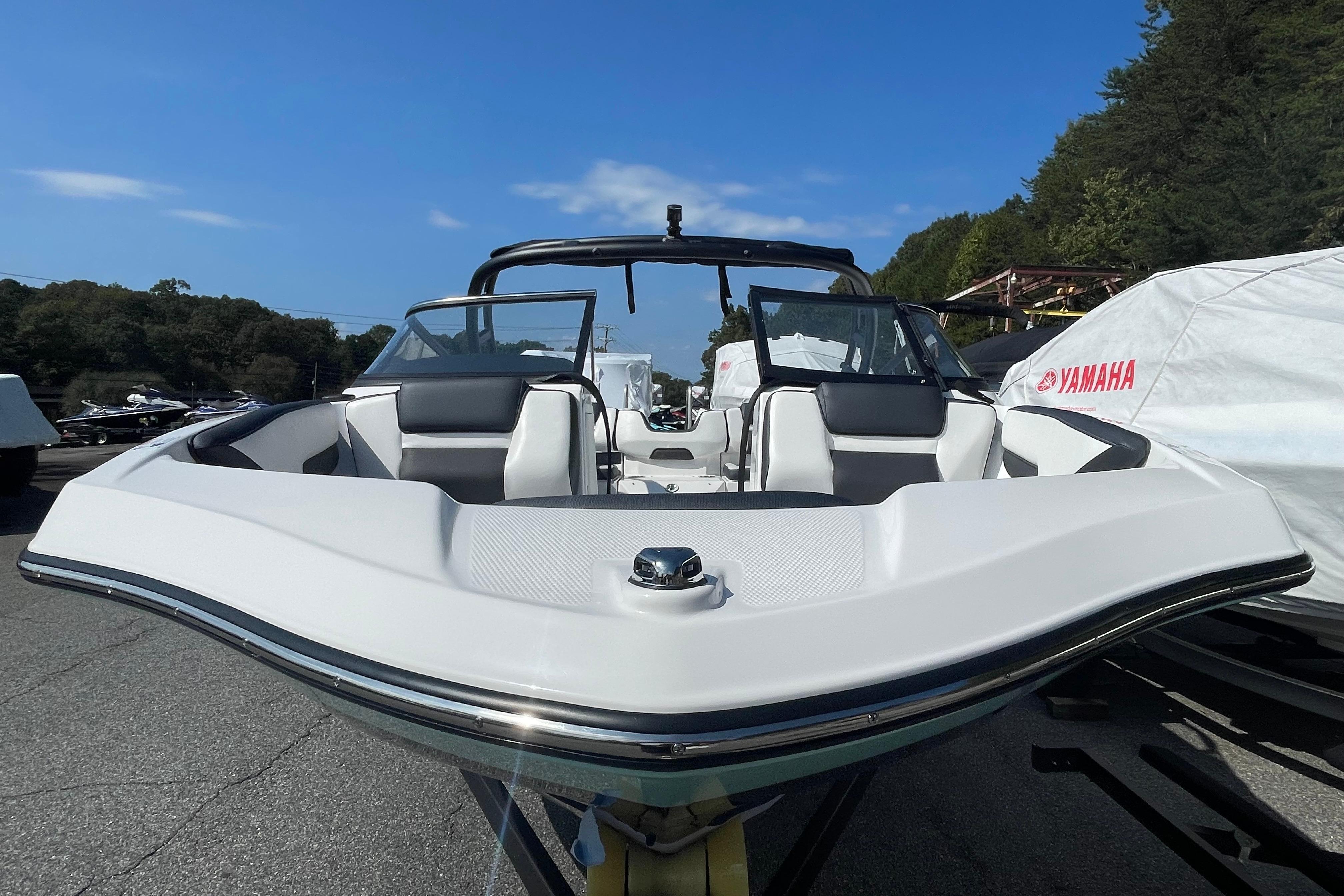2026 Yamaha Boats AR195, sleek white design, parked outdoors under clear blue sky.
