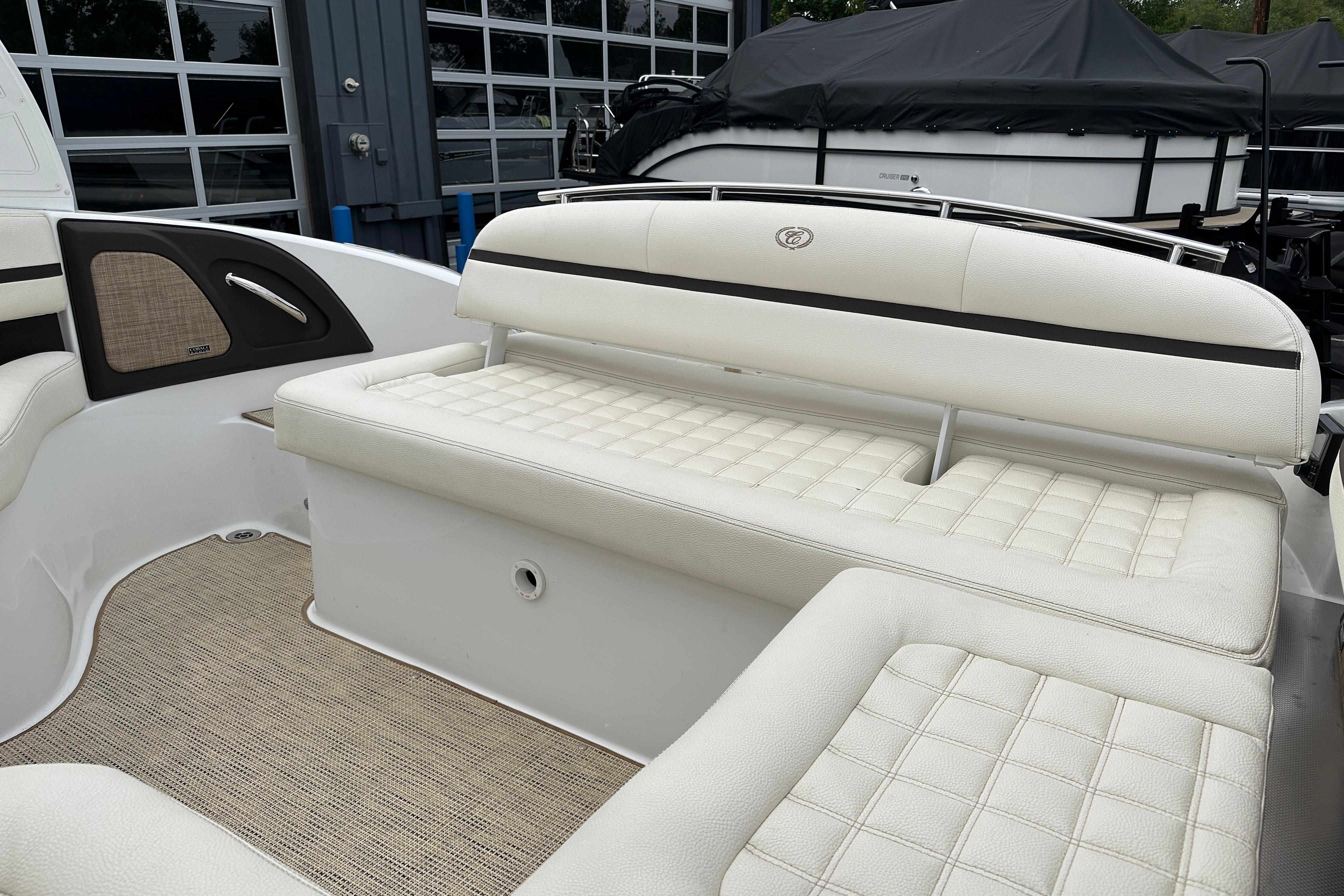 2019 Cobalt R5 boat interior with white cushioned seating and beige flooring.