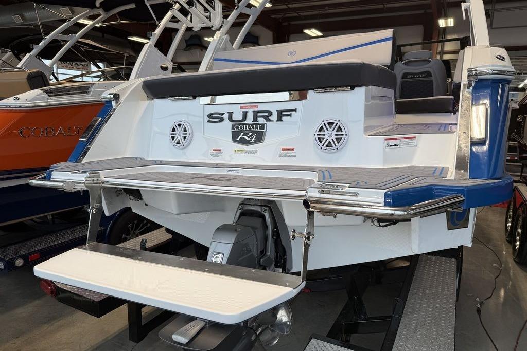 2026 Cobalt R4 Surf boat with swim platform in showroom.