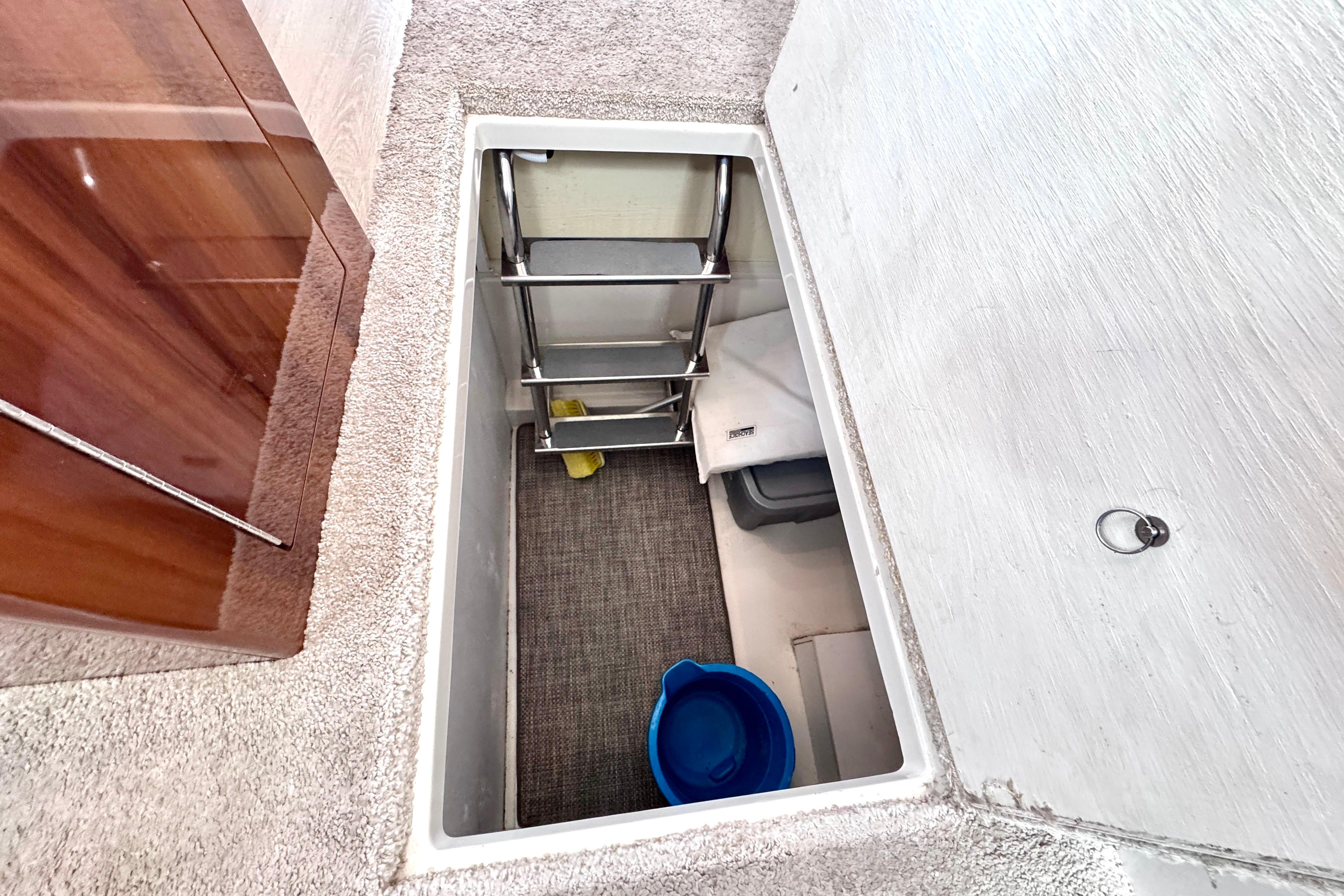 Storage compartment with ladder in 2015 Carver C37 yacht interior.
