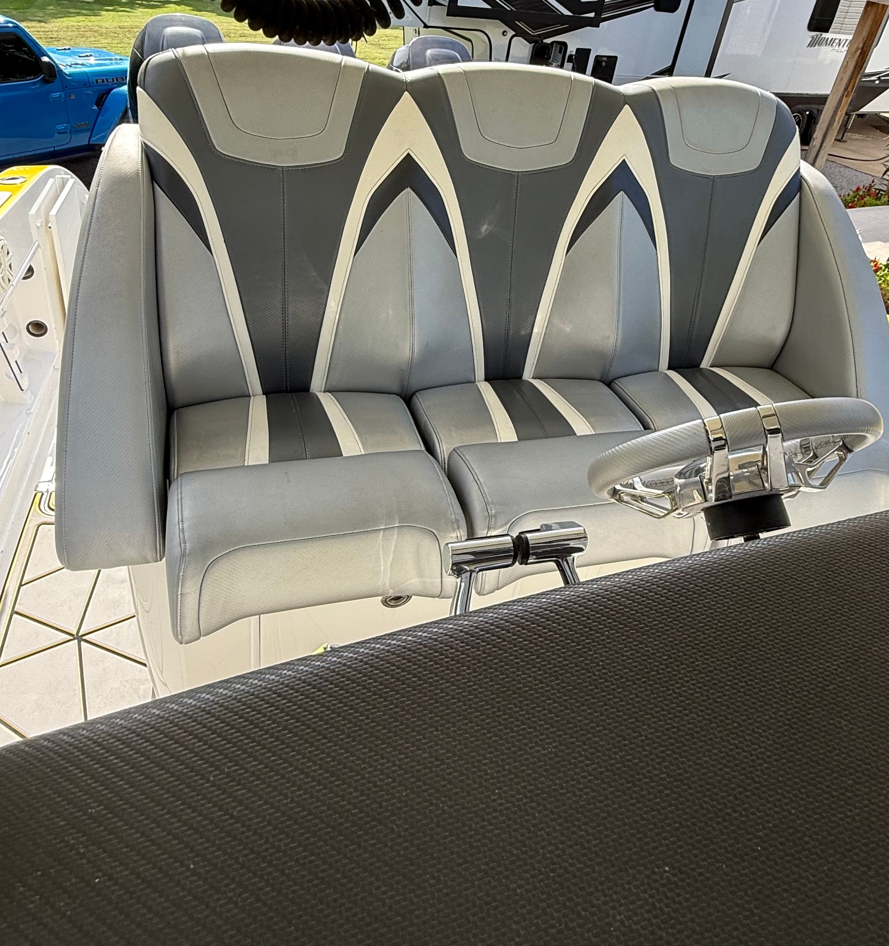 Seating area of a 2014 Sunsation 34 CCX with gray and white upholstery.