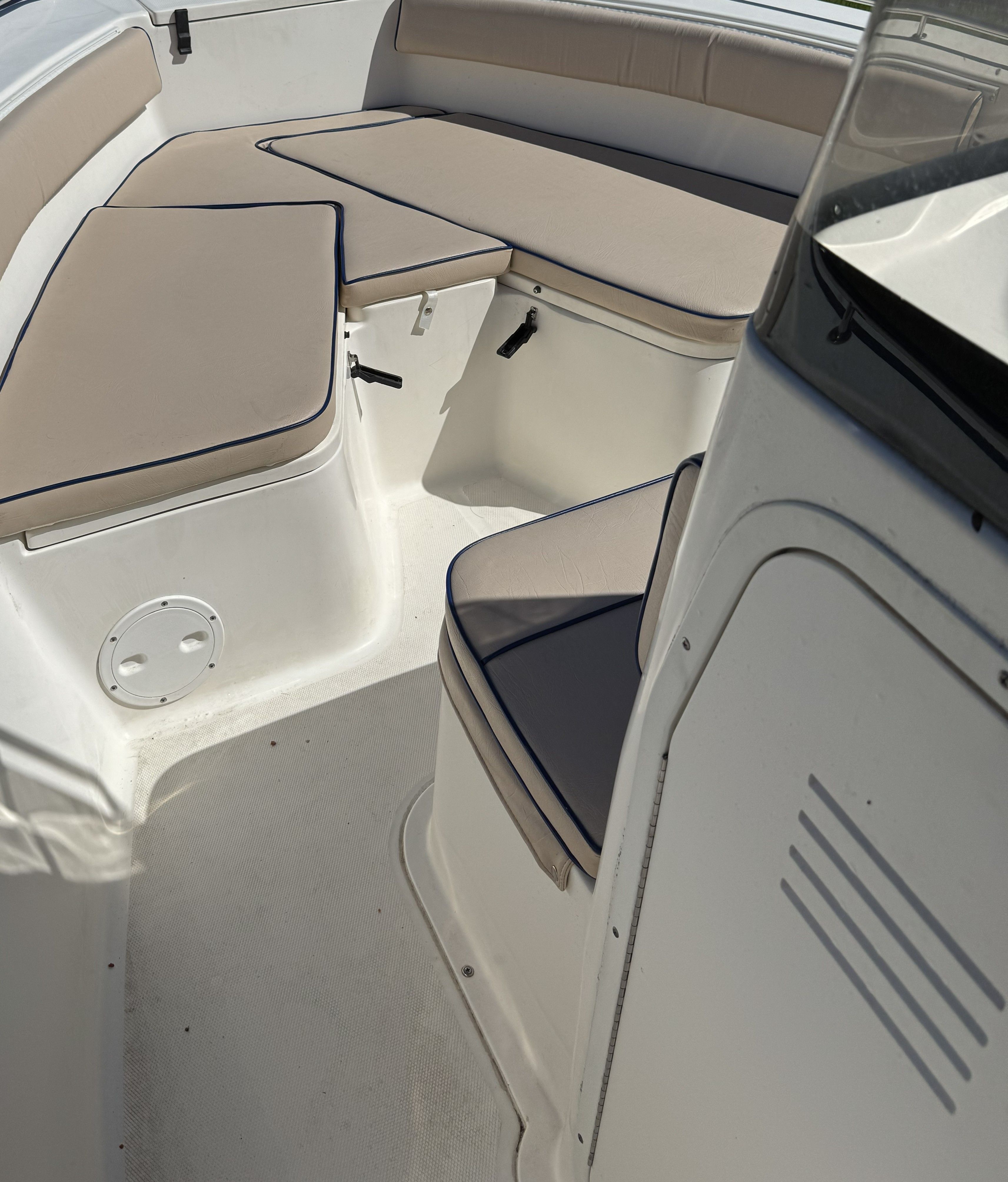 Interior of a 2004 Sea Hunt Triton boat with beige cushions.