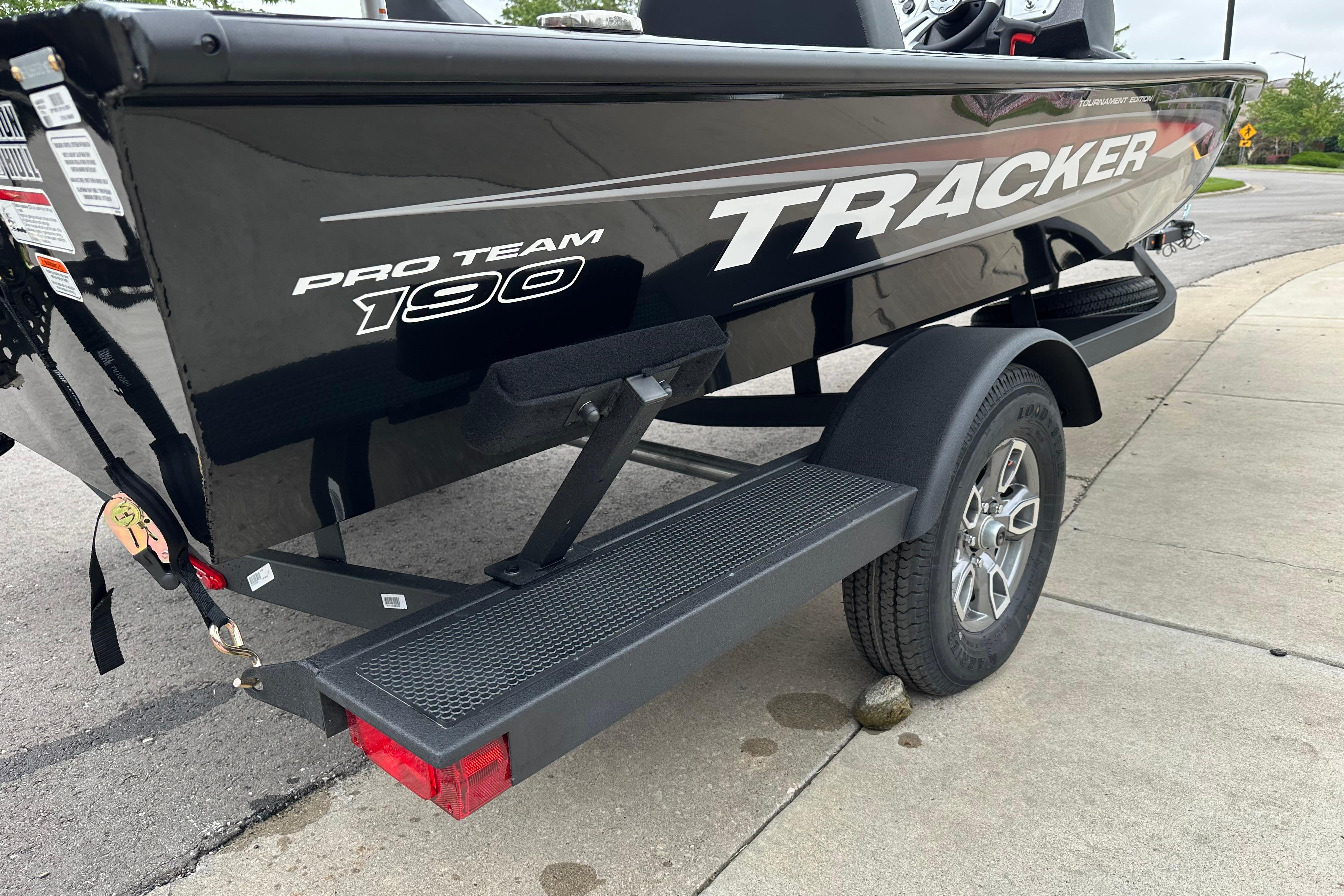 2026 Tracker Pro Team 190 boat on trailer, parked on pavement.