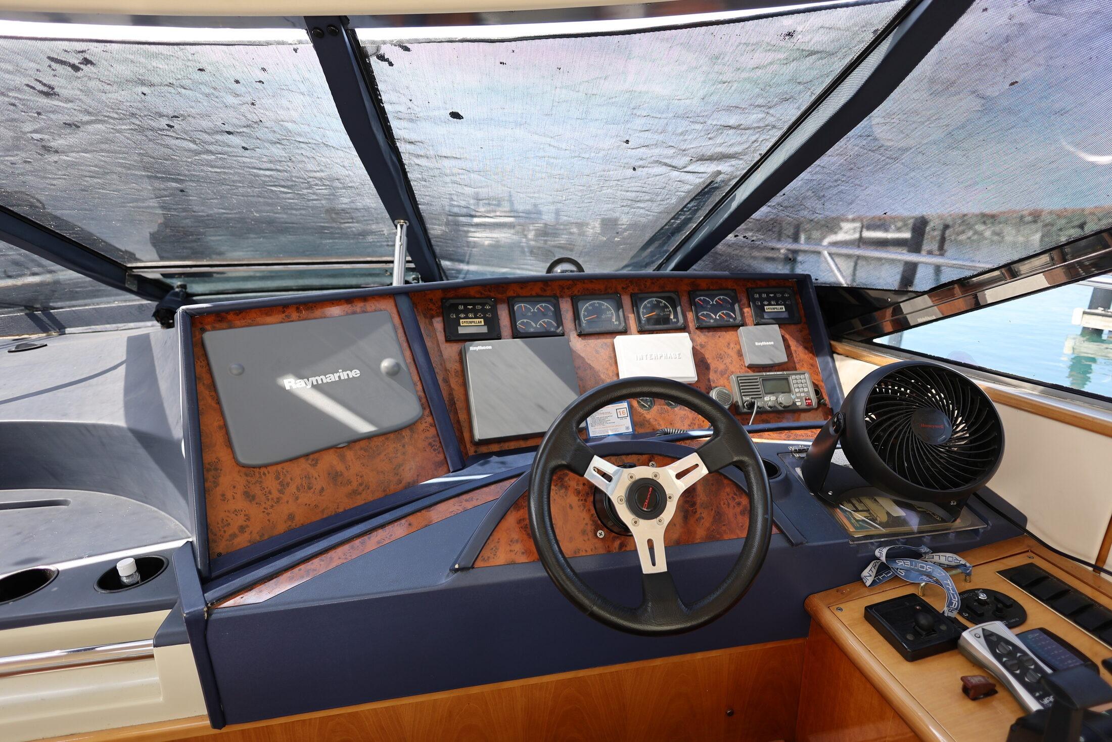 Cockpit of 1999 Neptunus 54 Express yacht with steering wheel and navigation equipment.