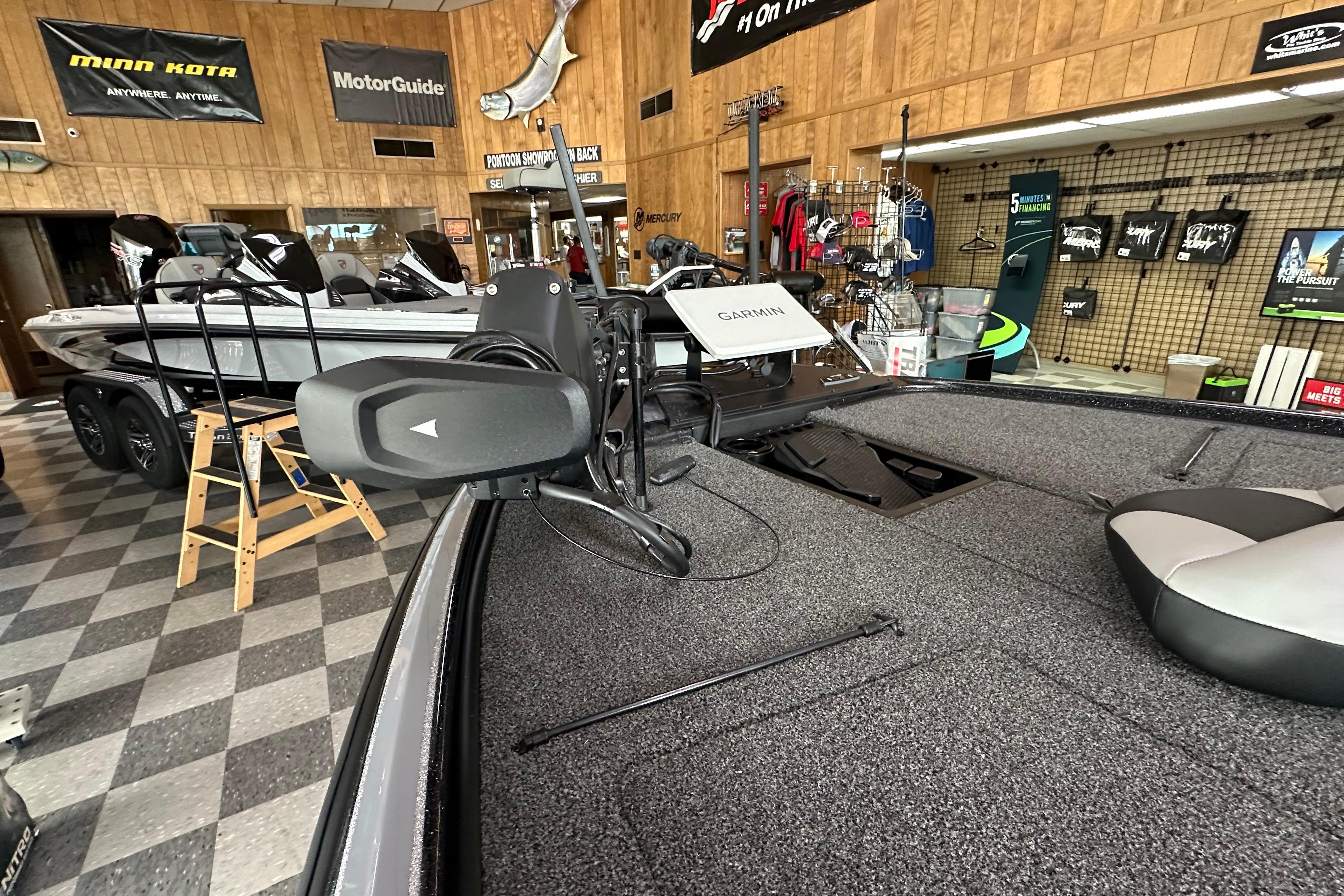2025 Nitro Z20 XL Pro boat displayed in a showroom with fishing equipment.