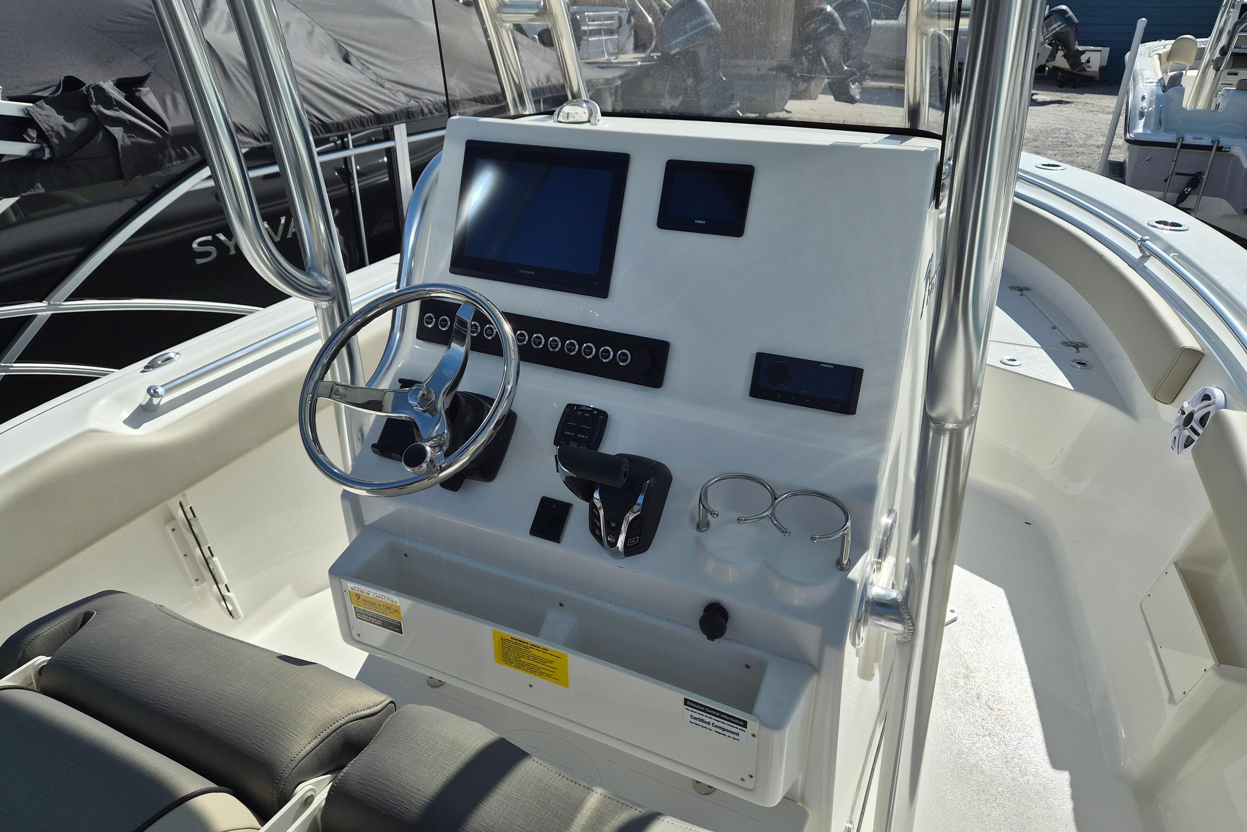 2026 Key West 239 FS boat dashboard with steering wheel and electronic controls.