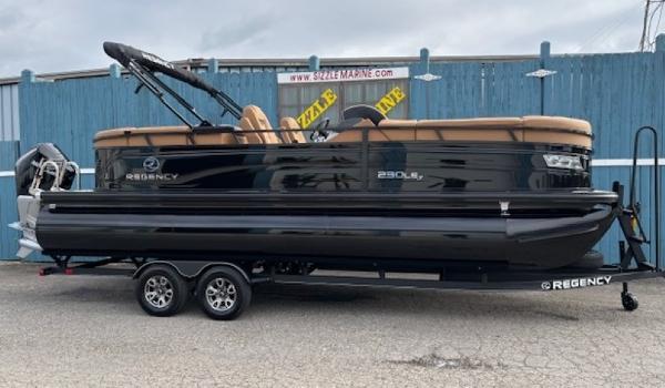2025 Regency 230 LE3 pontoon boat on trailer, sleek black design.