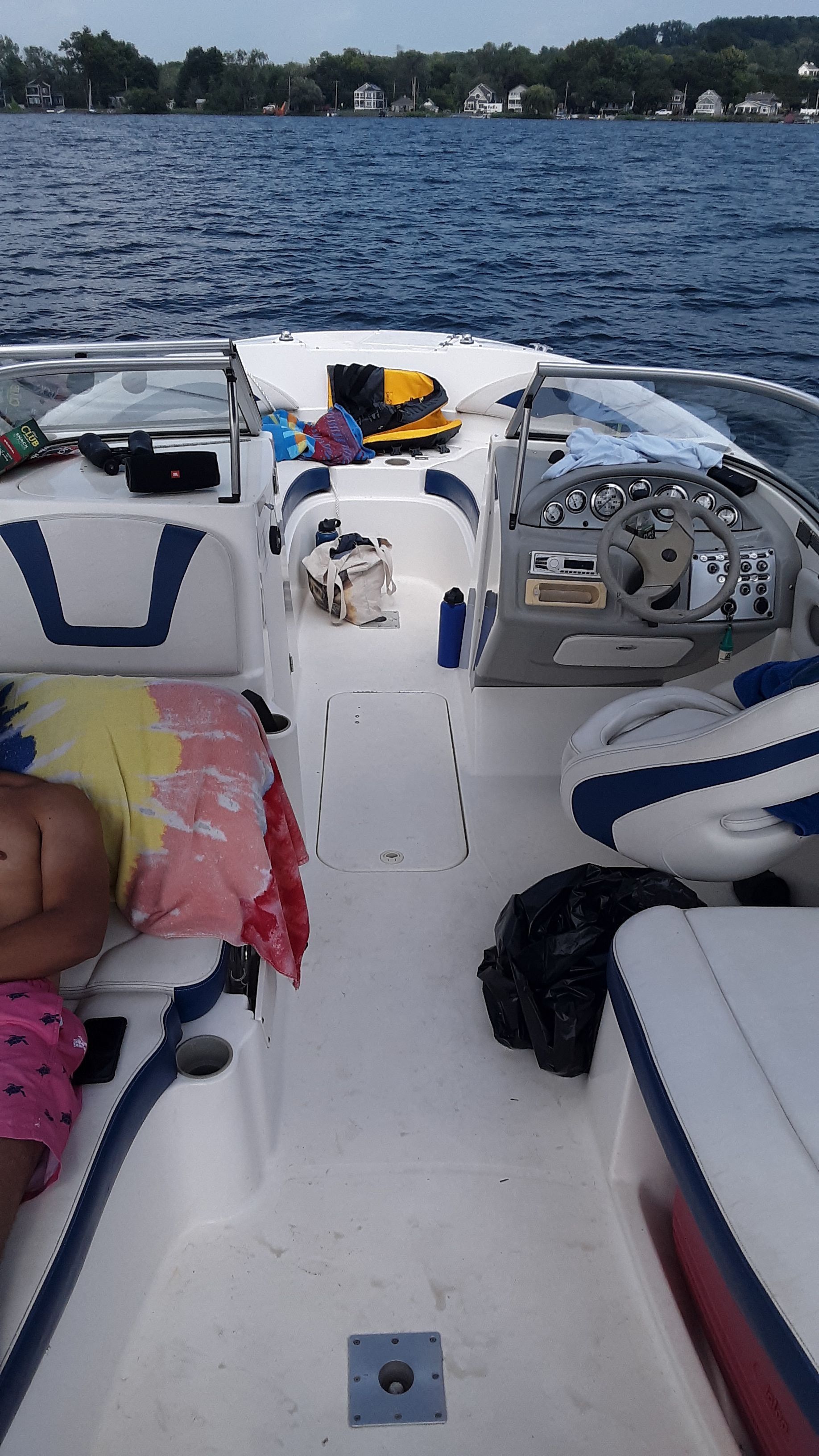 The image shows the cockpit of a 2005 Bayliner 210 Classic on a lake.