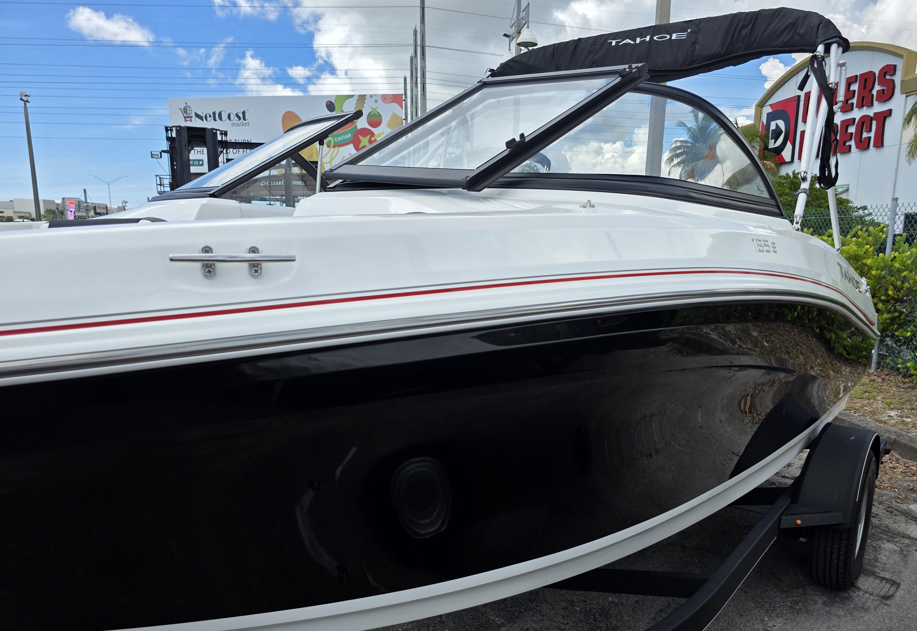 2024 Tahoe 185 S boat with sleek black and white design, parked outdoors.