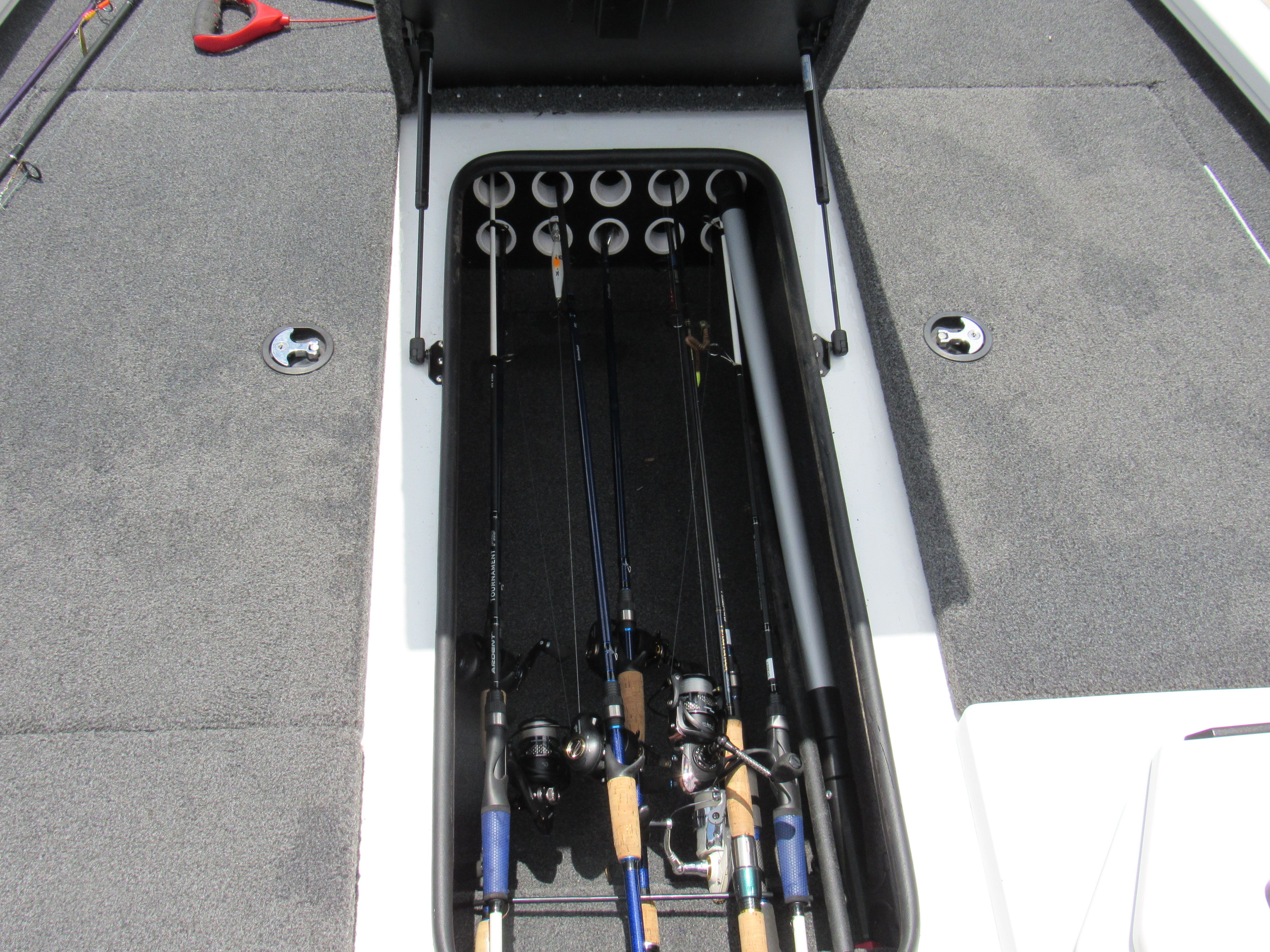 Fishing rods stored in a boat compartment.