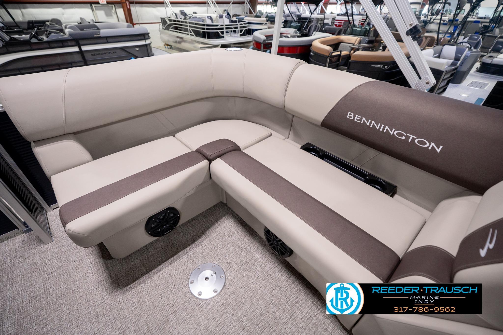 2026 Bennington 168 SF boat interior with beige and brown seating in showroom.