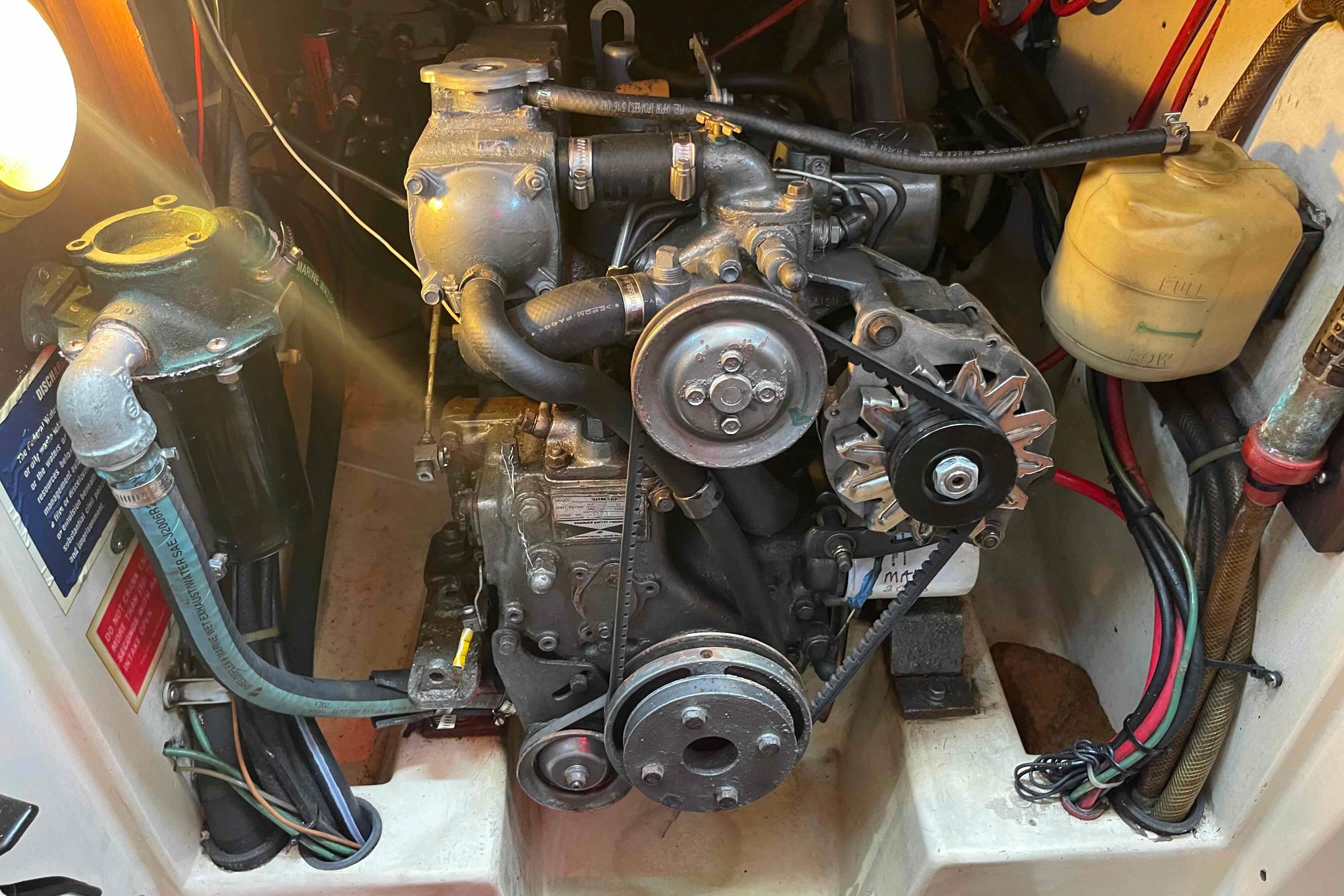 Engine compartment of a 1987 Pacific Seacraft 34 sailboat, showcasing mechanical components.