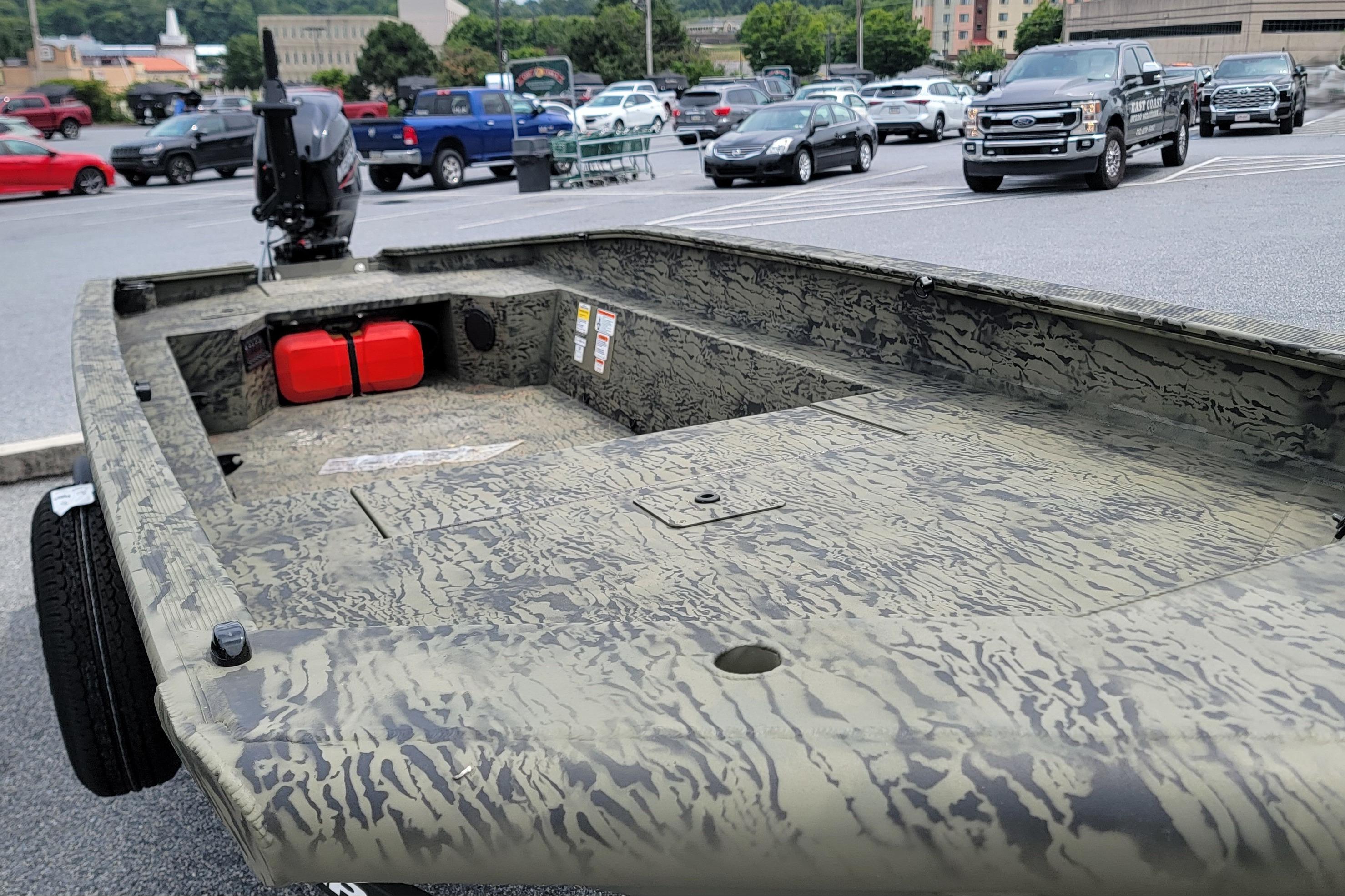 2026 Tracker Grizzly 1650 T Prairie Wings Edition boat in a parking lot.