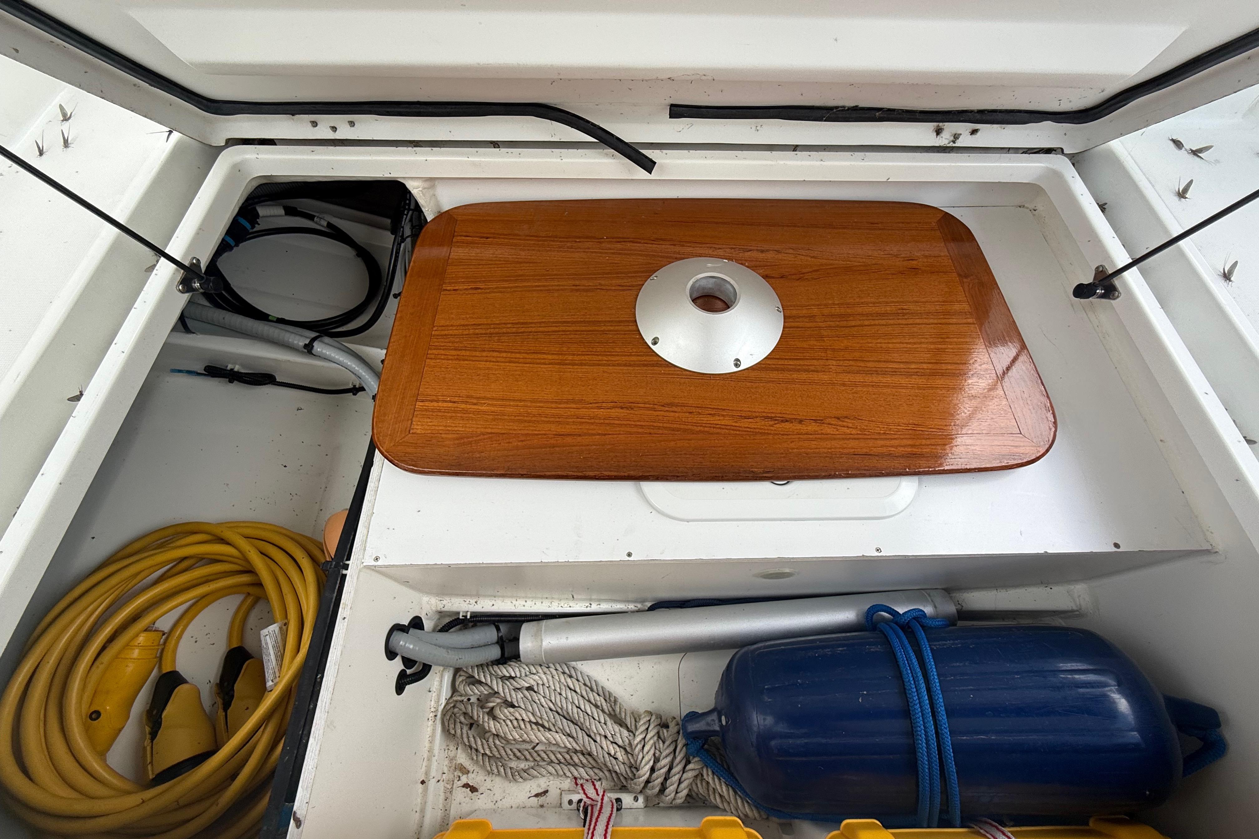 Storage compartment of a 2019 Beneteau Antares 23 boat with equipment and accessories.