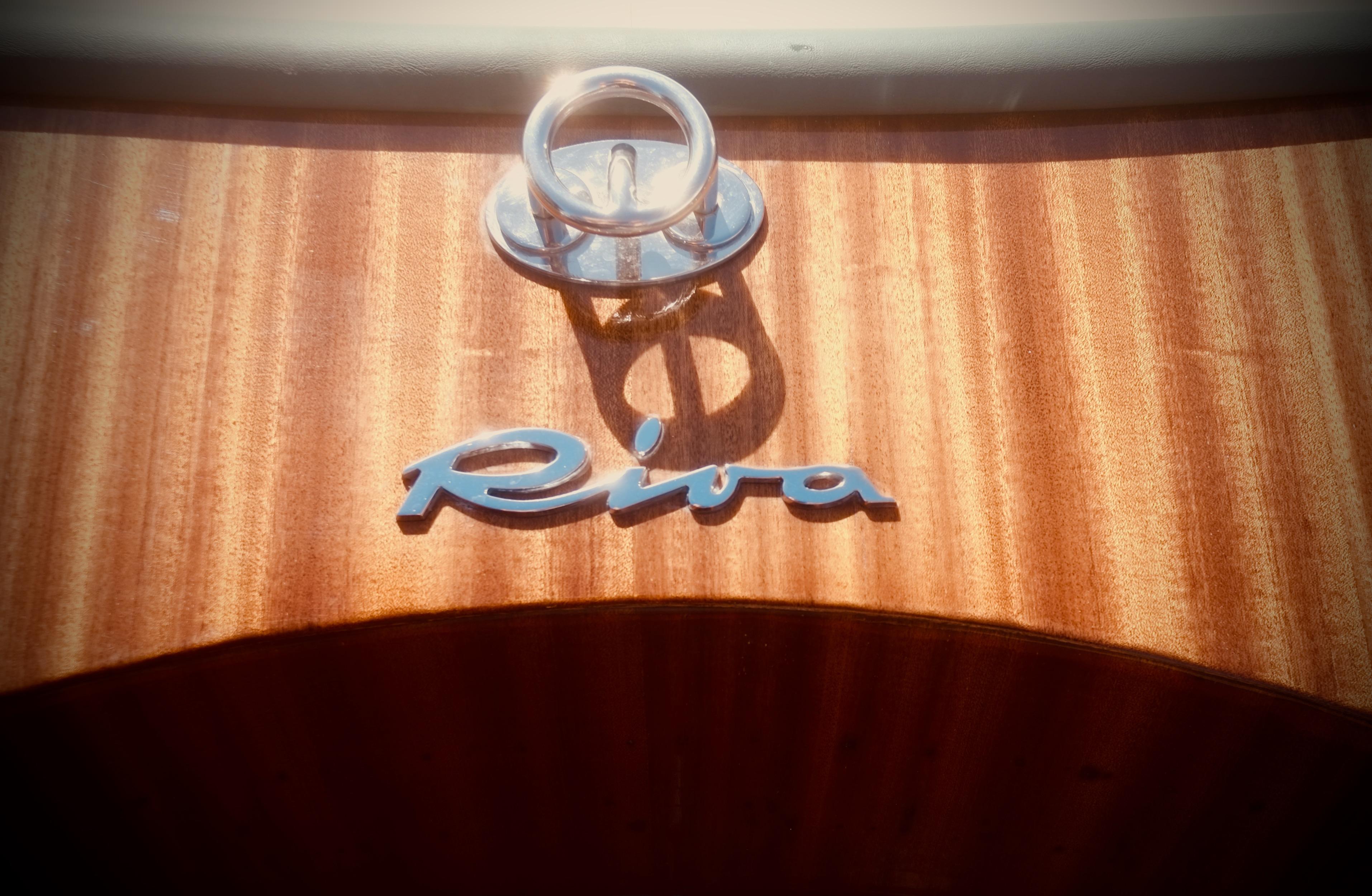 Riva Aquariva 33 boat emblem on polished wooden surface, 2003 model.