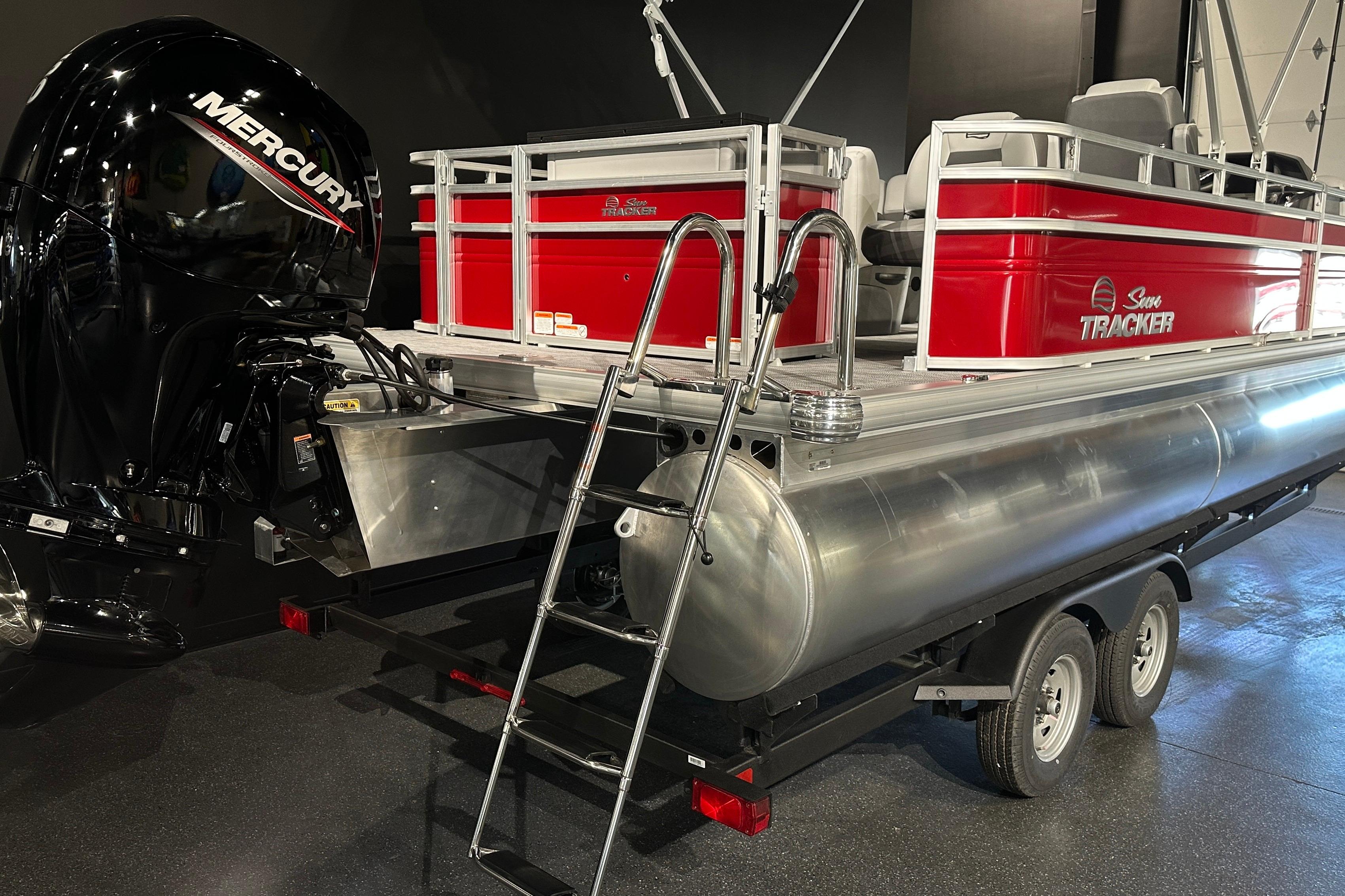 2026 Sun Tracker SportFish 22 DLX pontoon boat with Mercury engine on trailer.