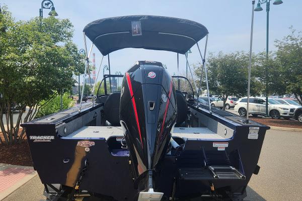 2024 Tracker Targa V-18 WT boat with outboard motor and canopy, rear view.