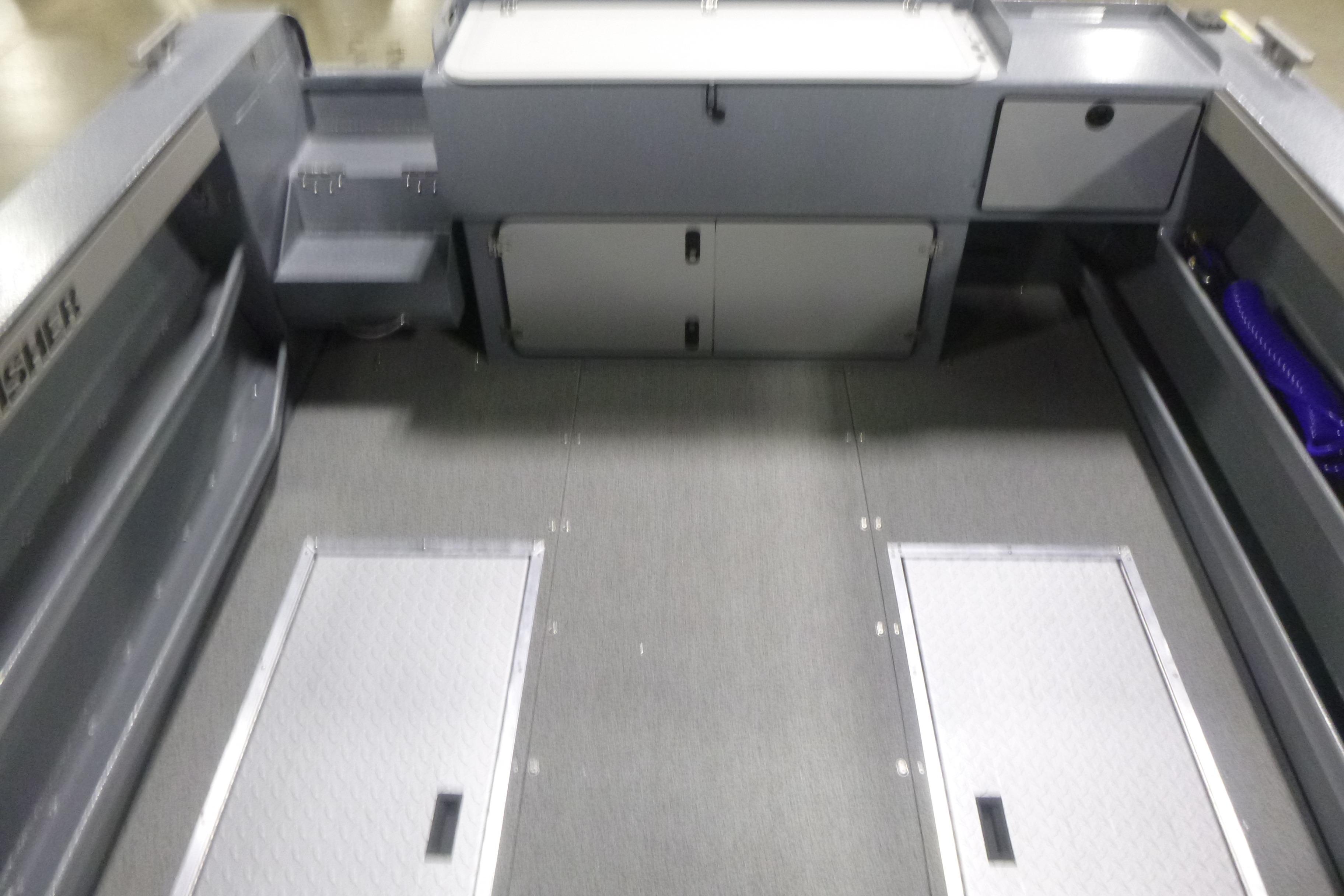 Interior of 2026 KingFisher 2425 Escape HT boat, featuring storage compartments and seating.