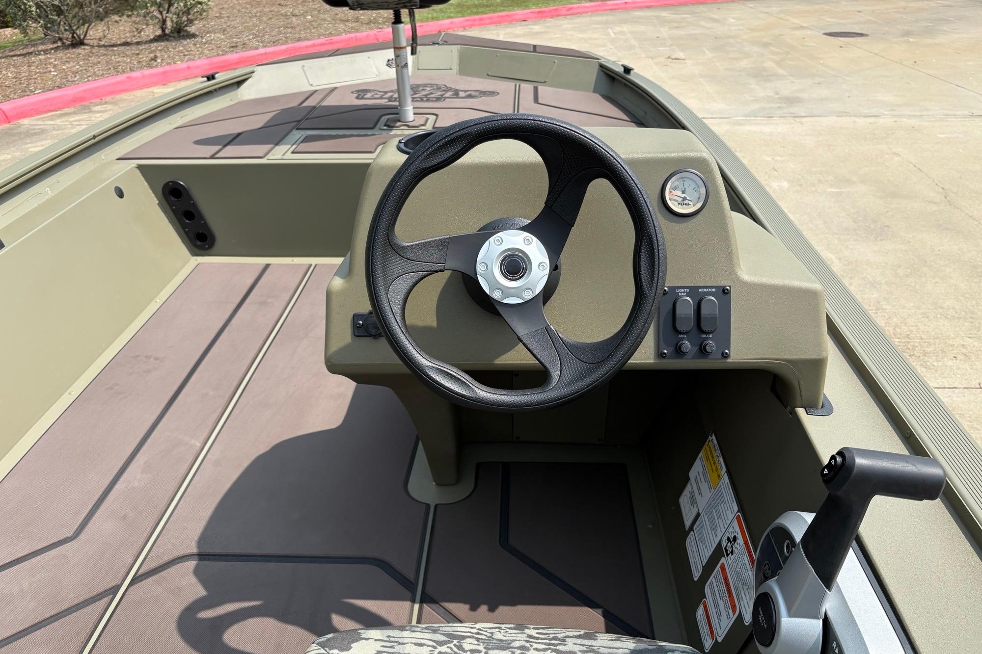 2026 Tracker Grizzly 1754 SC boat interior with steering wheel and control panel.