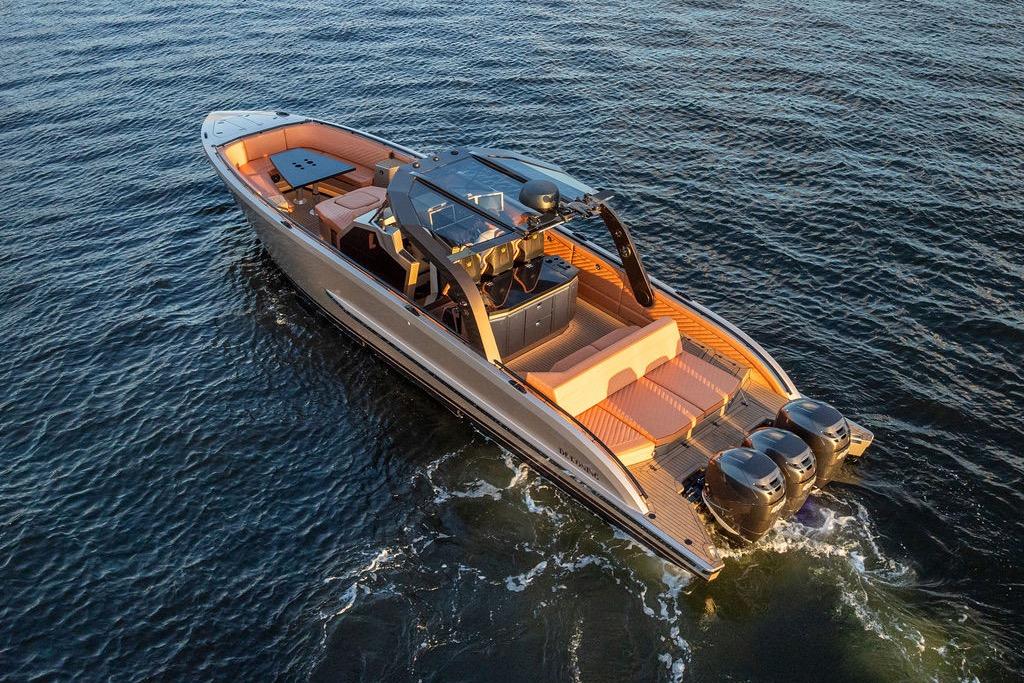 Luxury DeKoning 43 yacht cruising on open water, 2023 model, with sleek design and powerful engines.